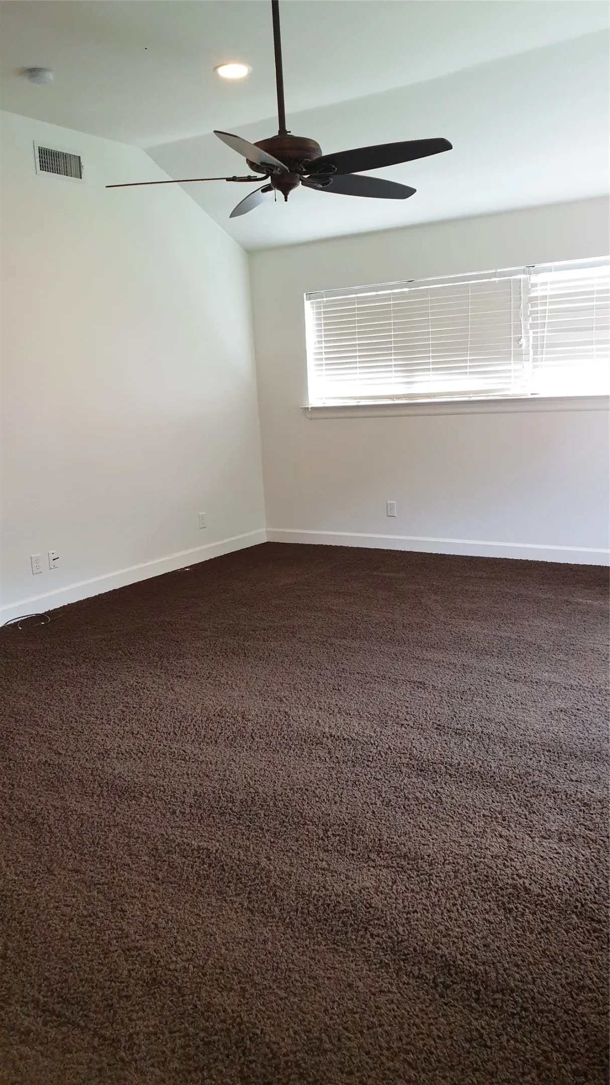 Vaulted ceilings, a ceiling fan, and