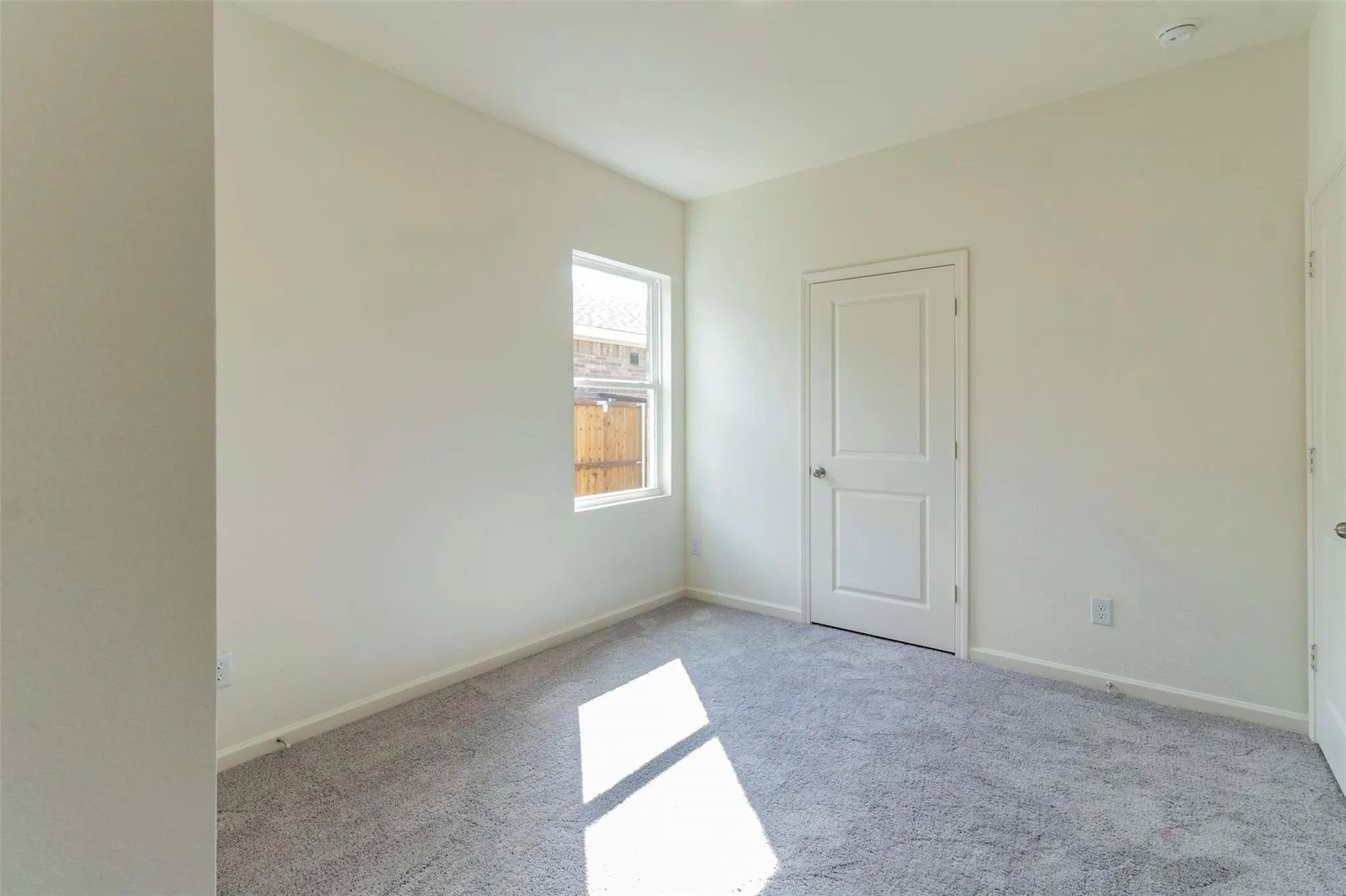 Neutral wall finishes, recessed ceiling lighting, light gray carpeting, and white interior doors with satin nickel hardware