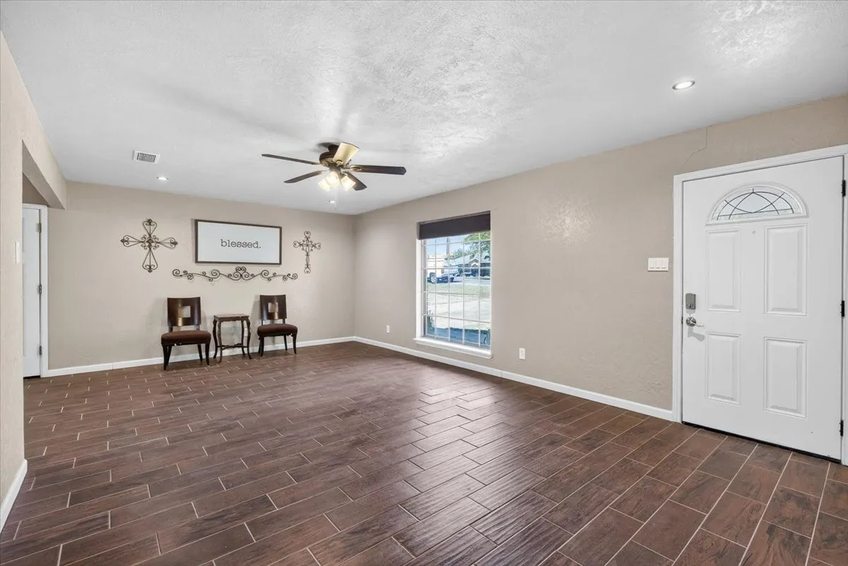Living room with wood looking tile flooring and neutral paint color
