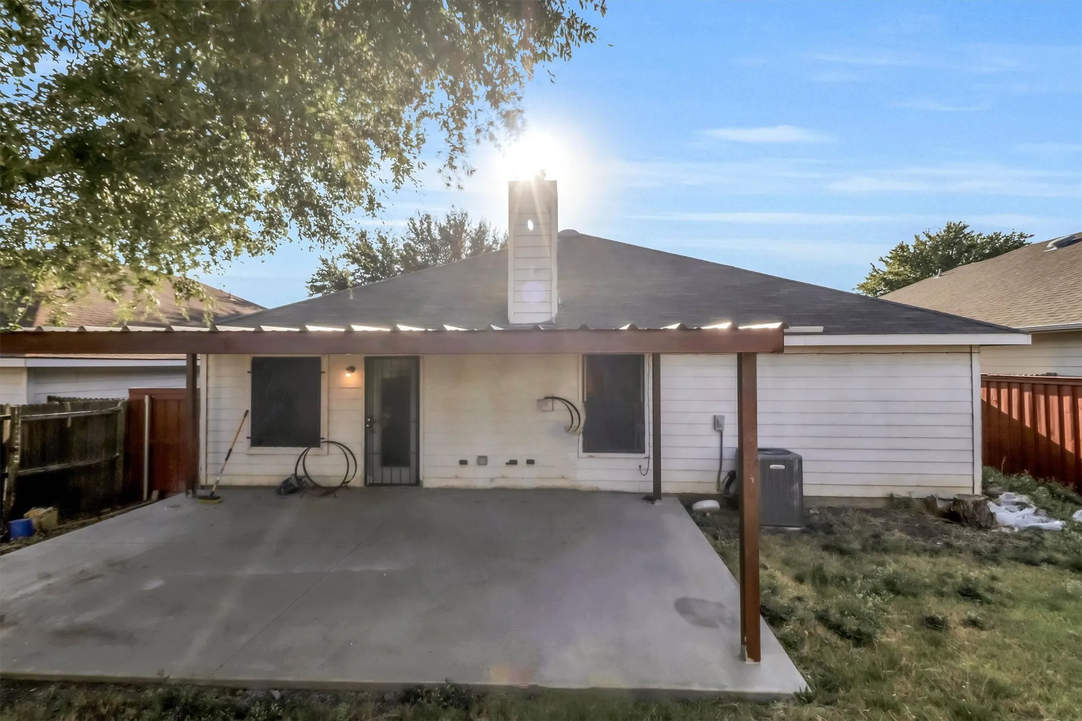 Patio area featuring a wood pergola and concrete slab