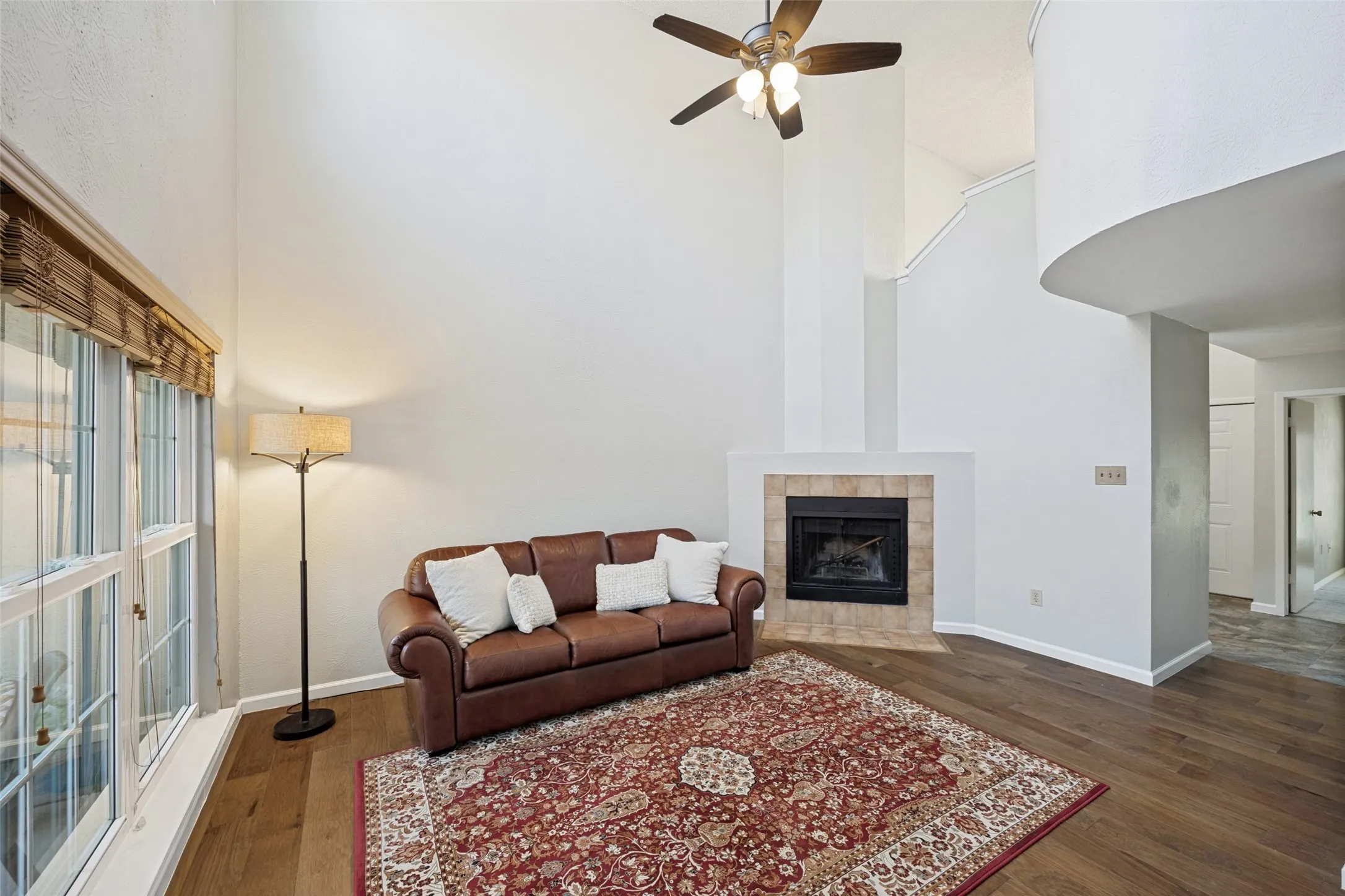 Vaulted ceiling with ceiling fan and fireplace and provides the perfect space for hosting