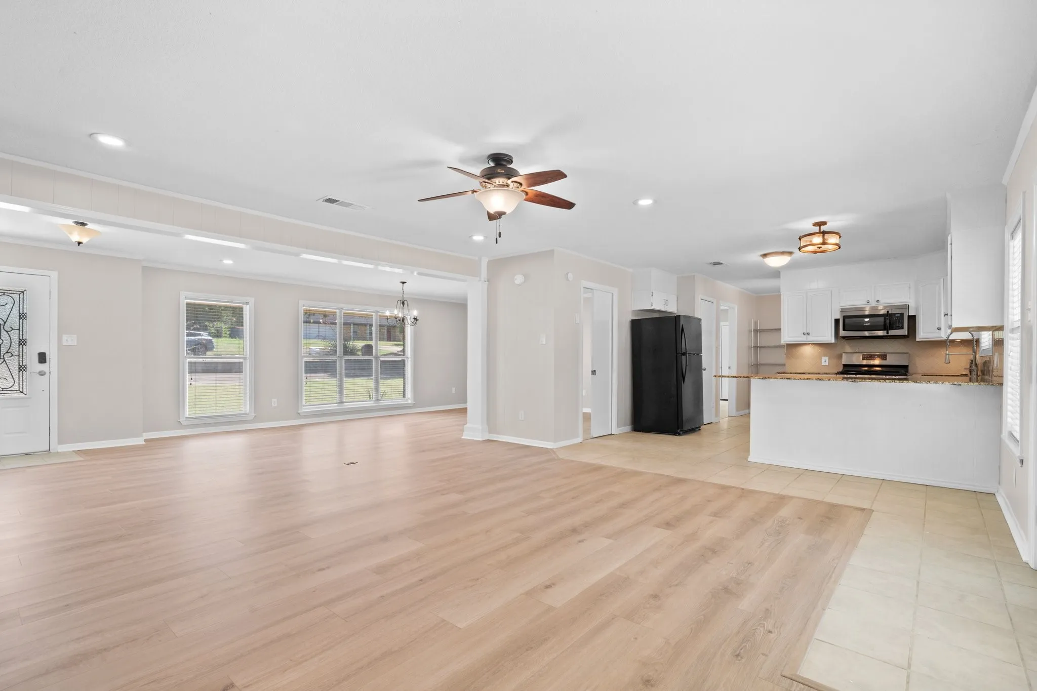 View of kitchen, dining room, entry