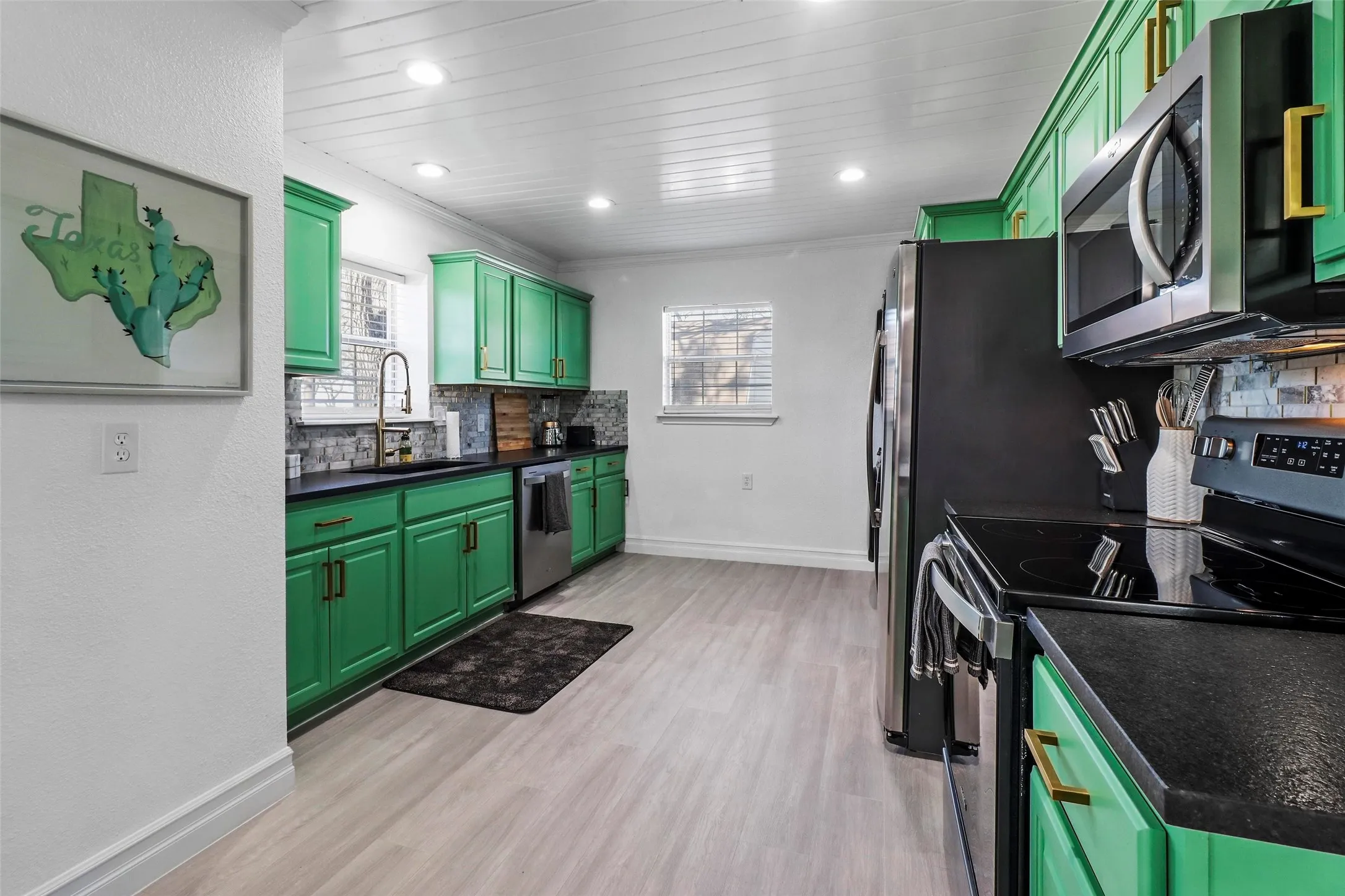Stylish countertops, gooseneck faucet, and designer cabinet hardware...move in ready