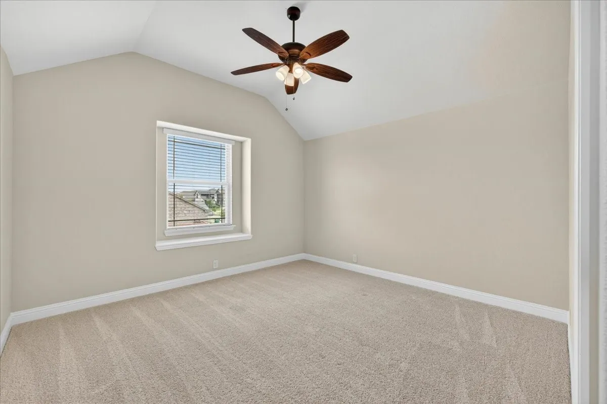 1st Bedroom has vaulted ceilings, light carpet and ceiling fan