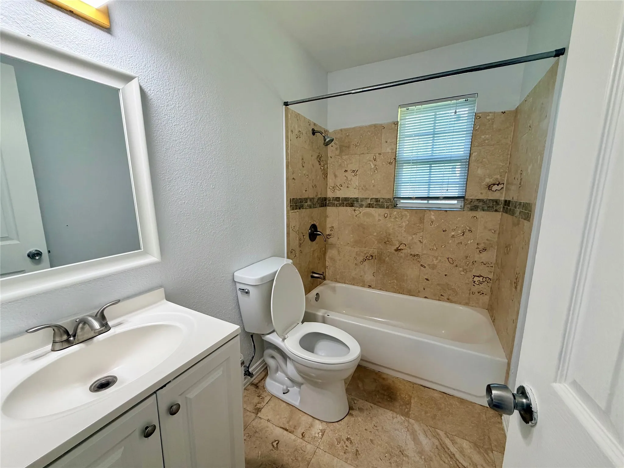 White vanity with an integrated sink and brushed nickel faucet