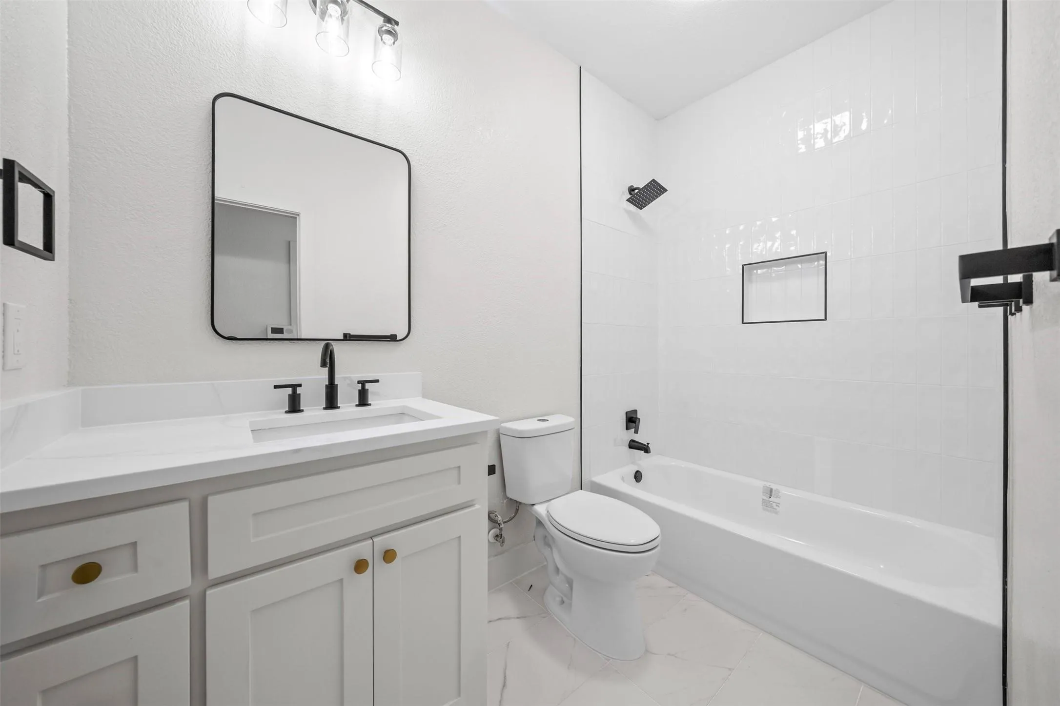 White vanity with a solid surface countertop and undermount sink
