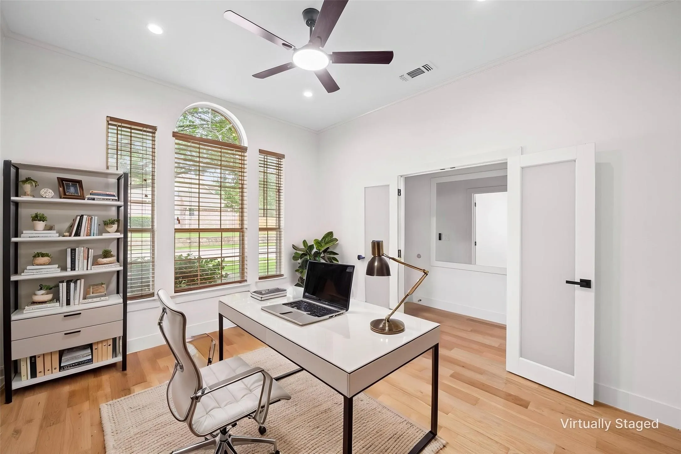 Hardwood-style flooring throughout with a modern ceiling fan and recessed lighting