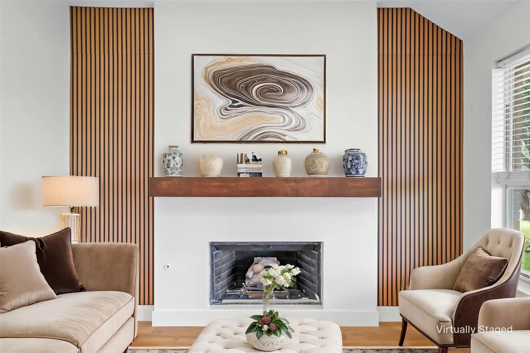 Contemporary fireplace with a substantial wood mantel, flanked by vertical wood paneling and a large window
