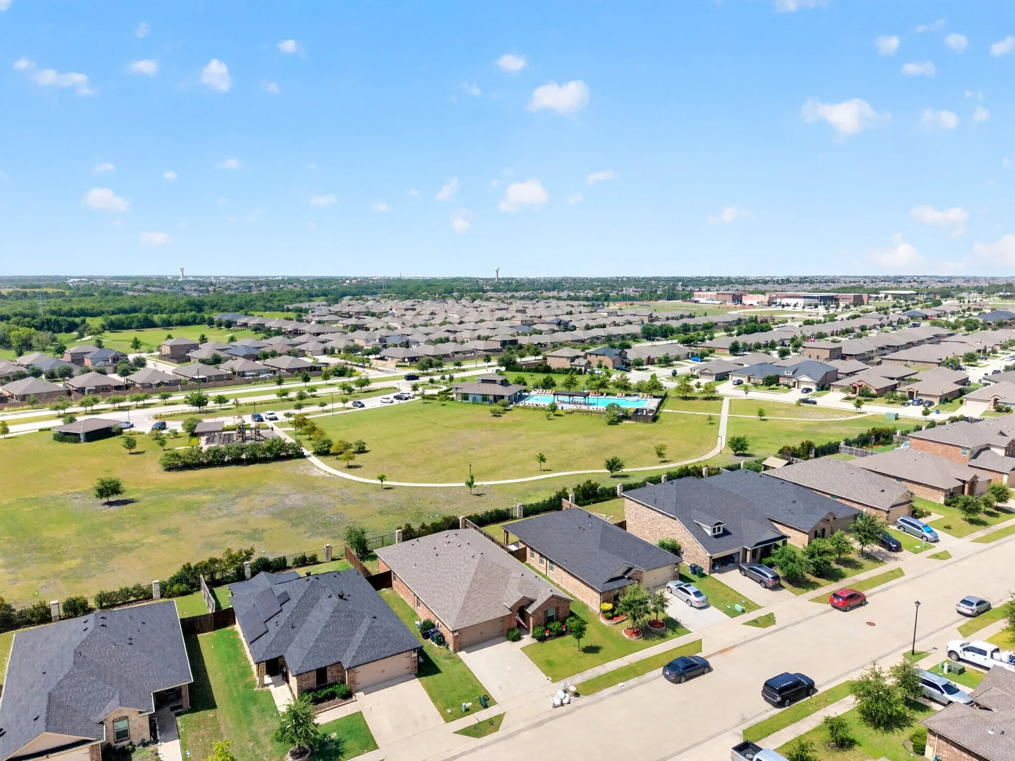 Expansive residential development featuring a community park, swimming pool, and dedicated green spaces