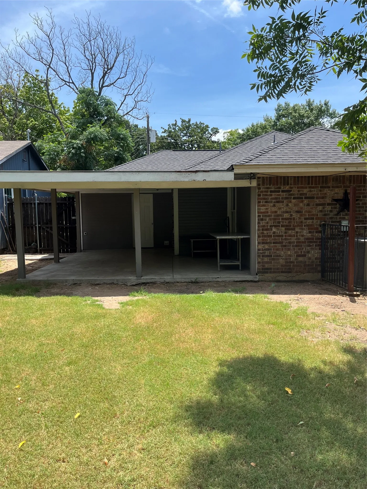 Back of property featuring a covered patio and yard.