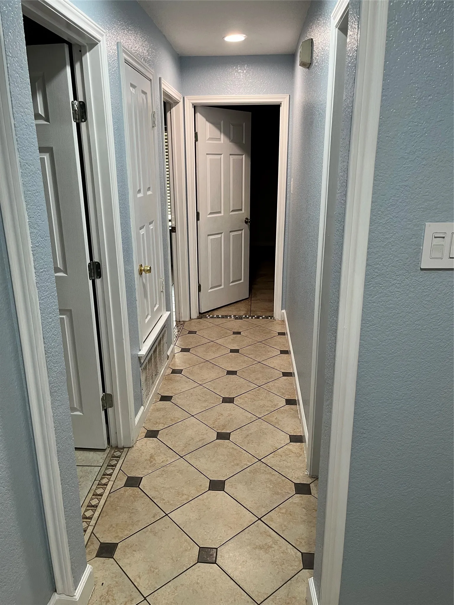 Hallway to main bathroom and 3 bedrooms.