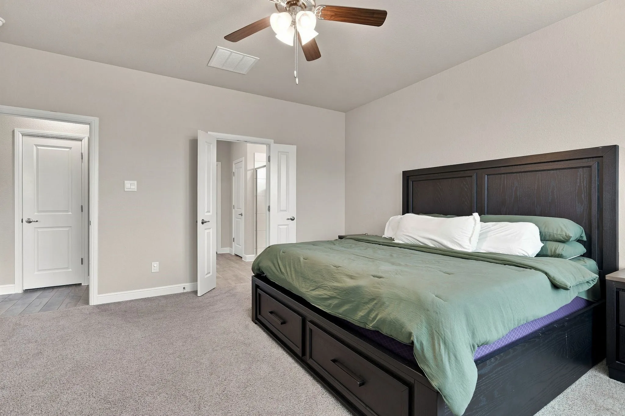 Recessed lighting, wood-finish ceiling fan, and light gray wall paint