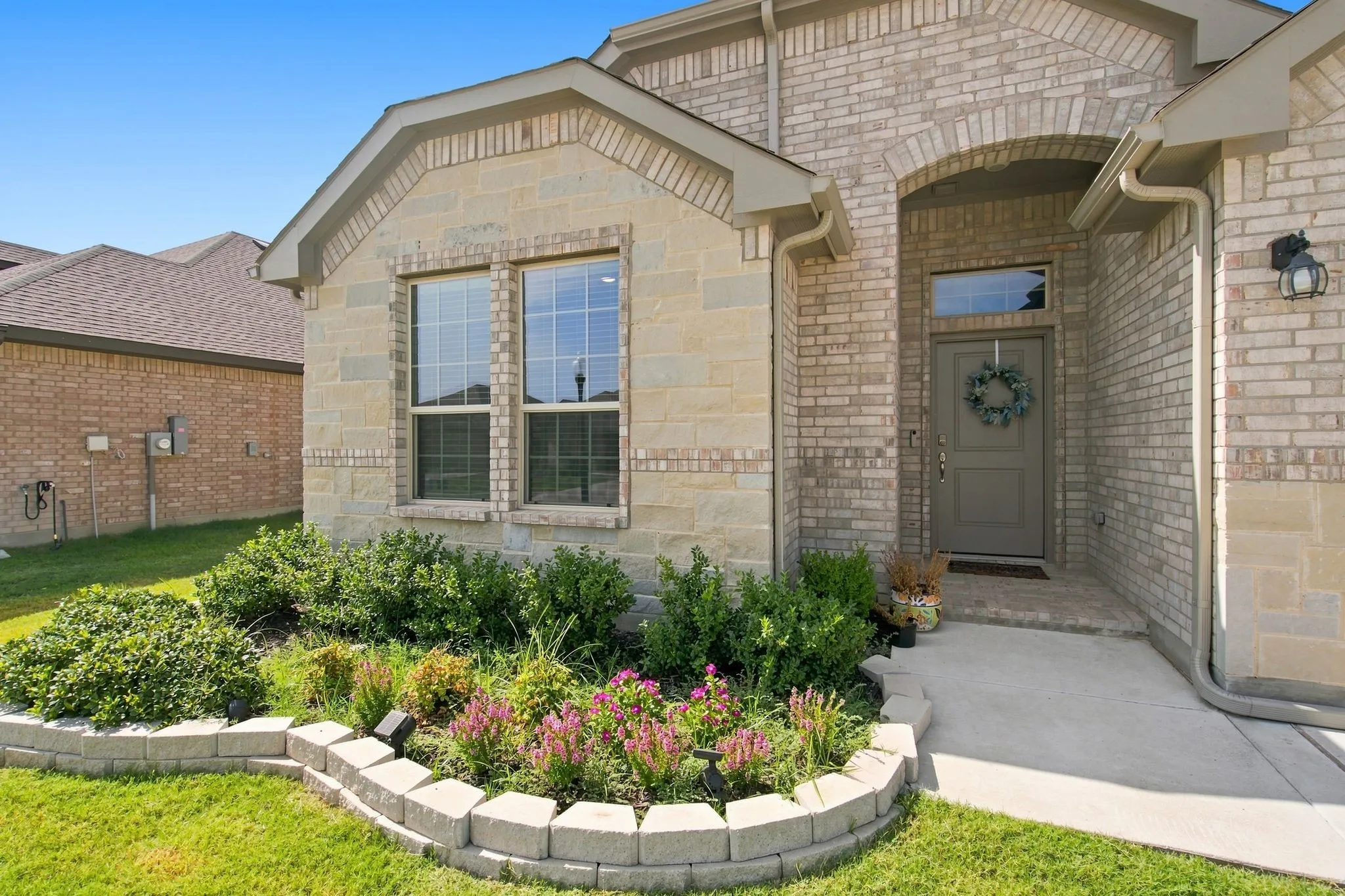 Brick and stone exterior with arched entry