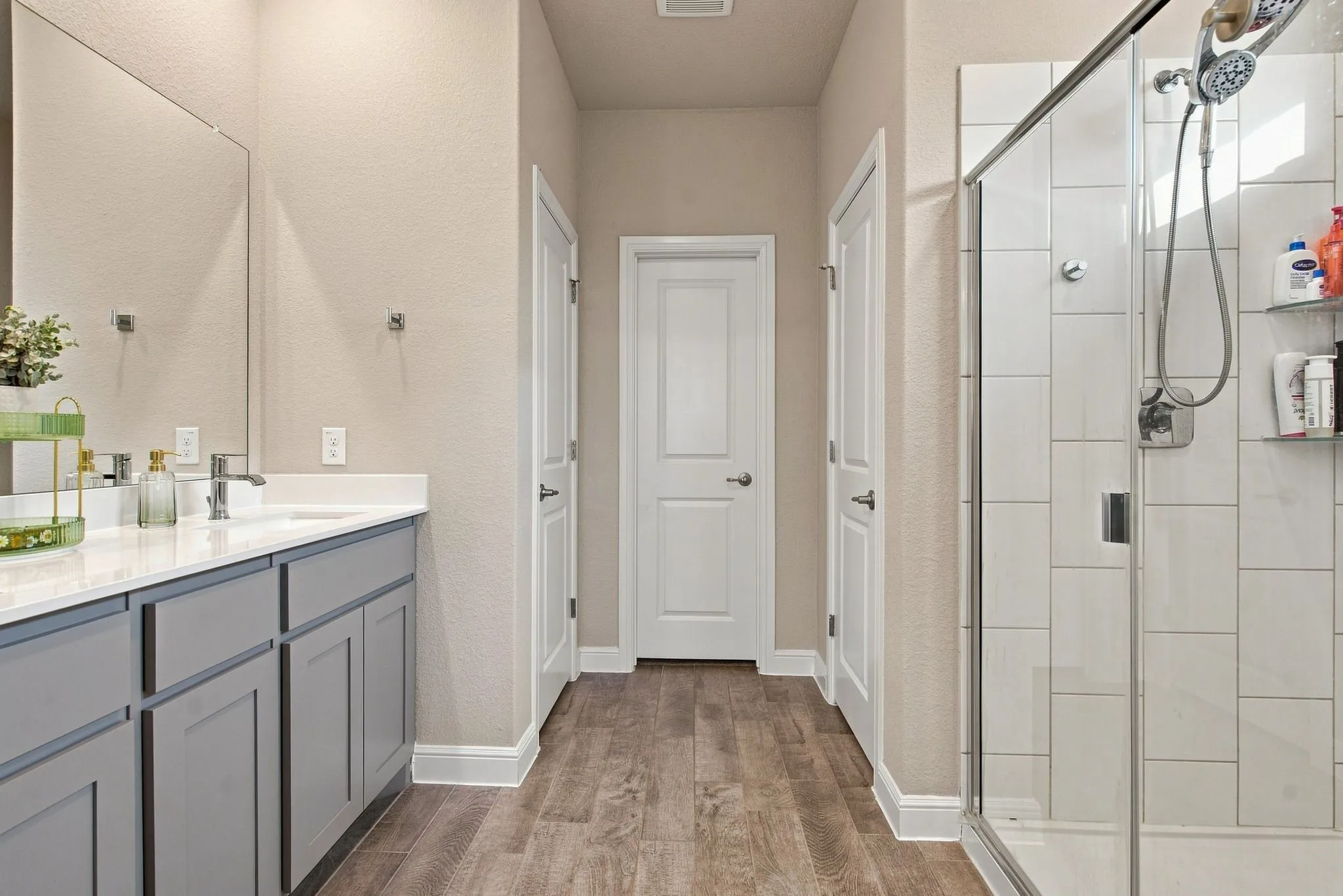 Vanity with gray shaker-style cabinetry and a white countertop