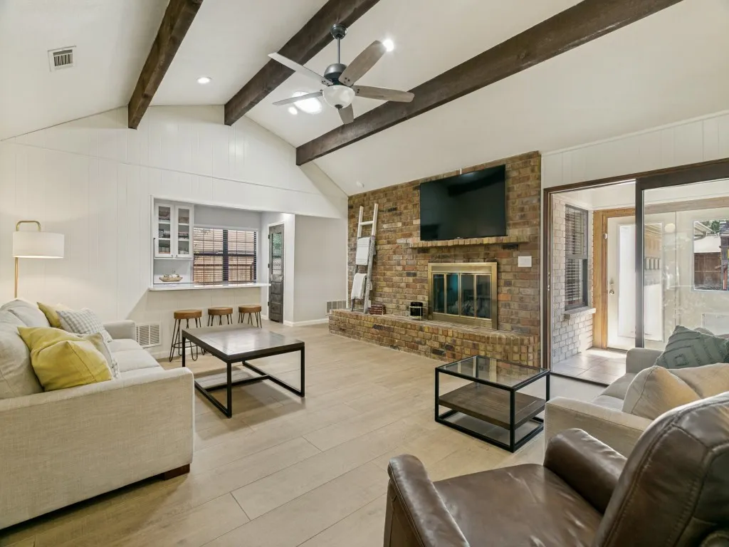 Wood-look ceramic tile creates a seamless flow through the main living spaces - with no carpet throughout the house.