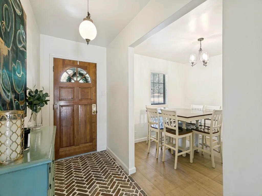 Step inside to a bright entry with wood-look ceramic tile flooring that continues throughout much of the home.