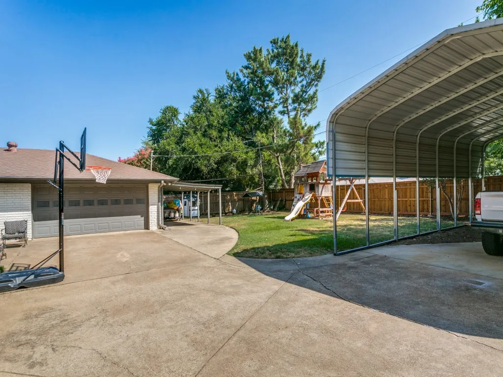 The property includes a 2-car side-entry garage, additional covered parking and an RV carport.