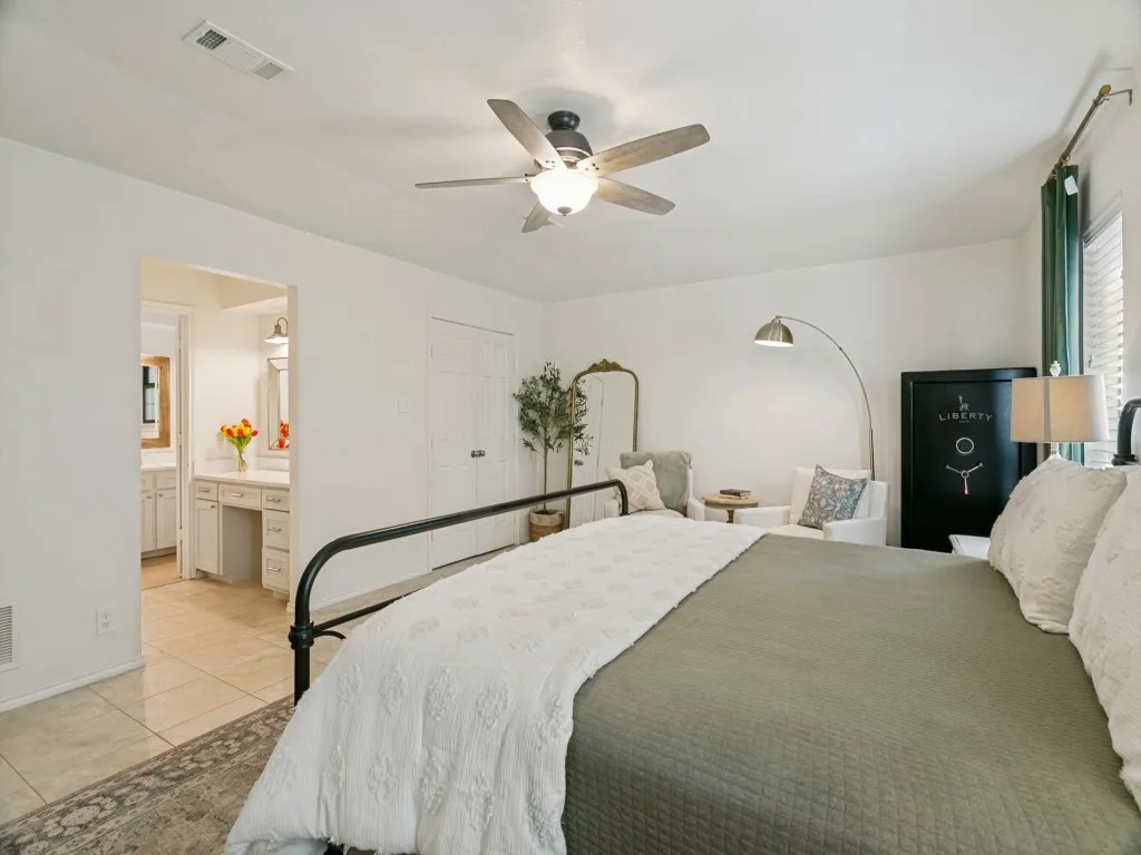 Another view of the primary suite highlights its generous proportions and private bath access.