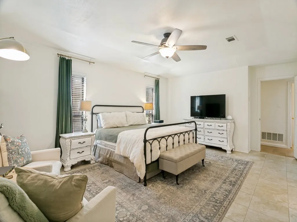 The oversized 20' x 20' primary suite offers exceptional space for both sleeping and sitting areas.