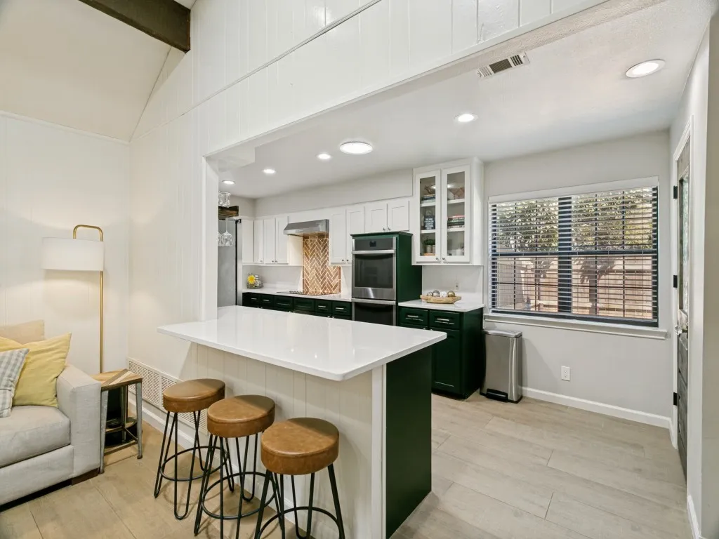 The large island/breakfast bar provides casual seating plus additional prep and serving space.