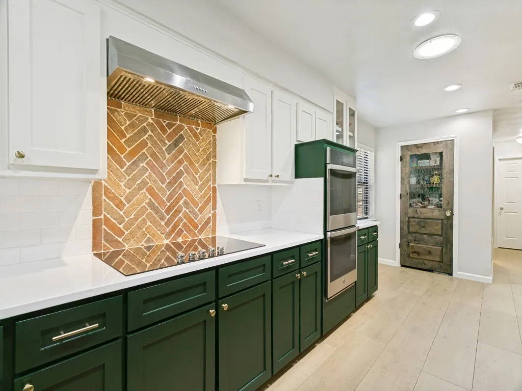 Thoughtful details include contrasting lower cabinetry, updated finishes and a separate pantry.
