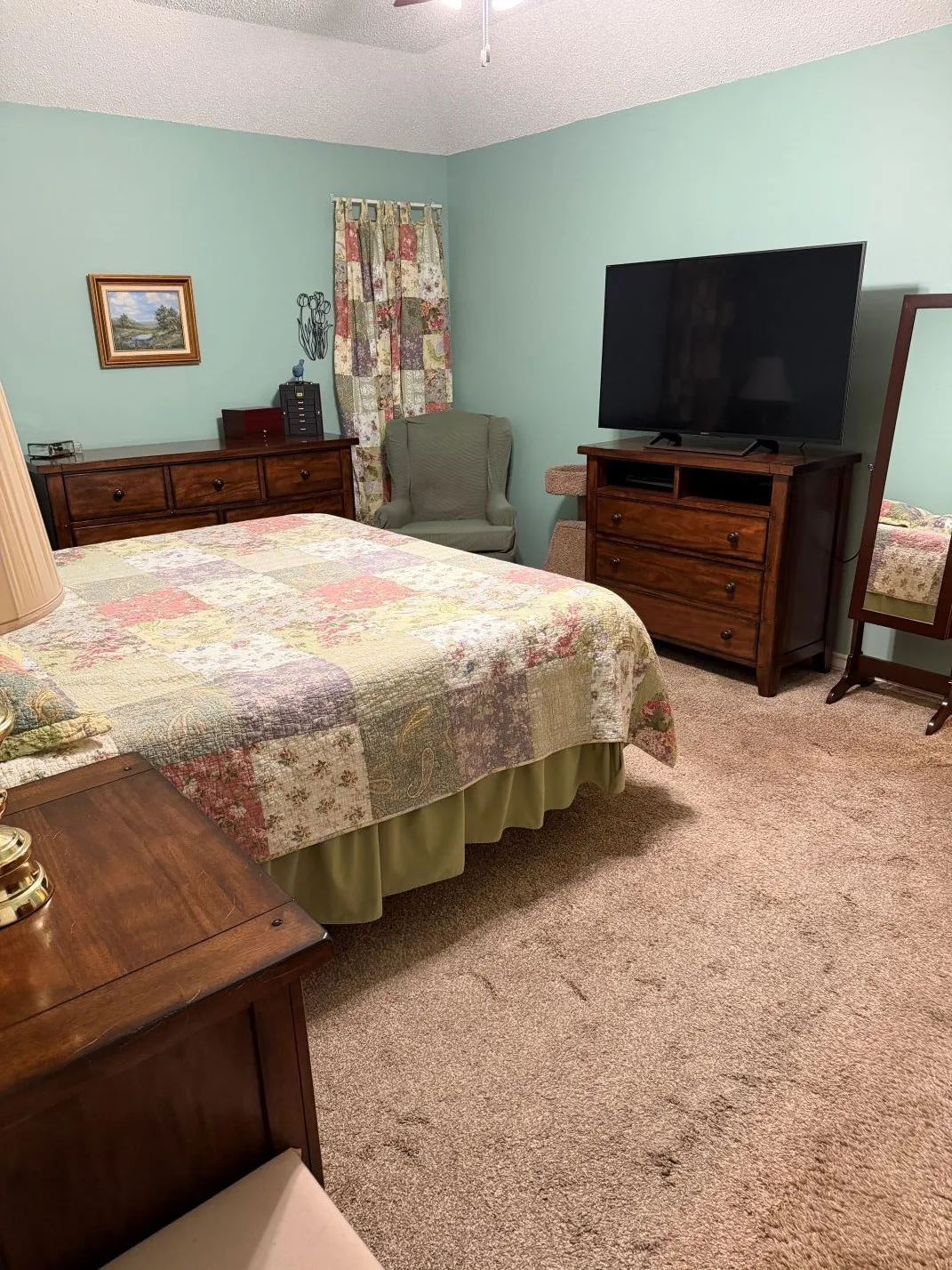 Wall-to-wall carpeting and a ceiling fan with integrated lighting