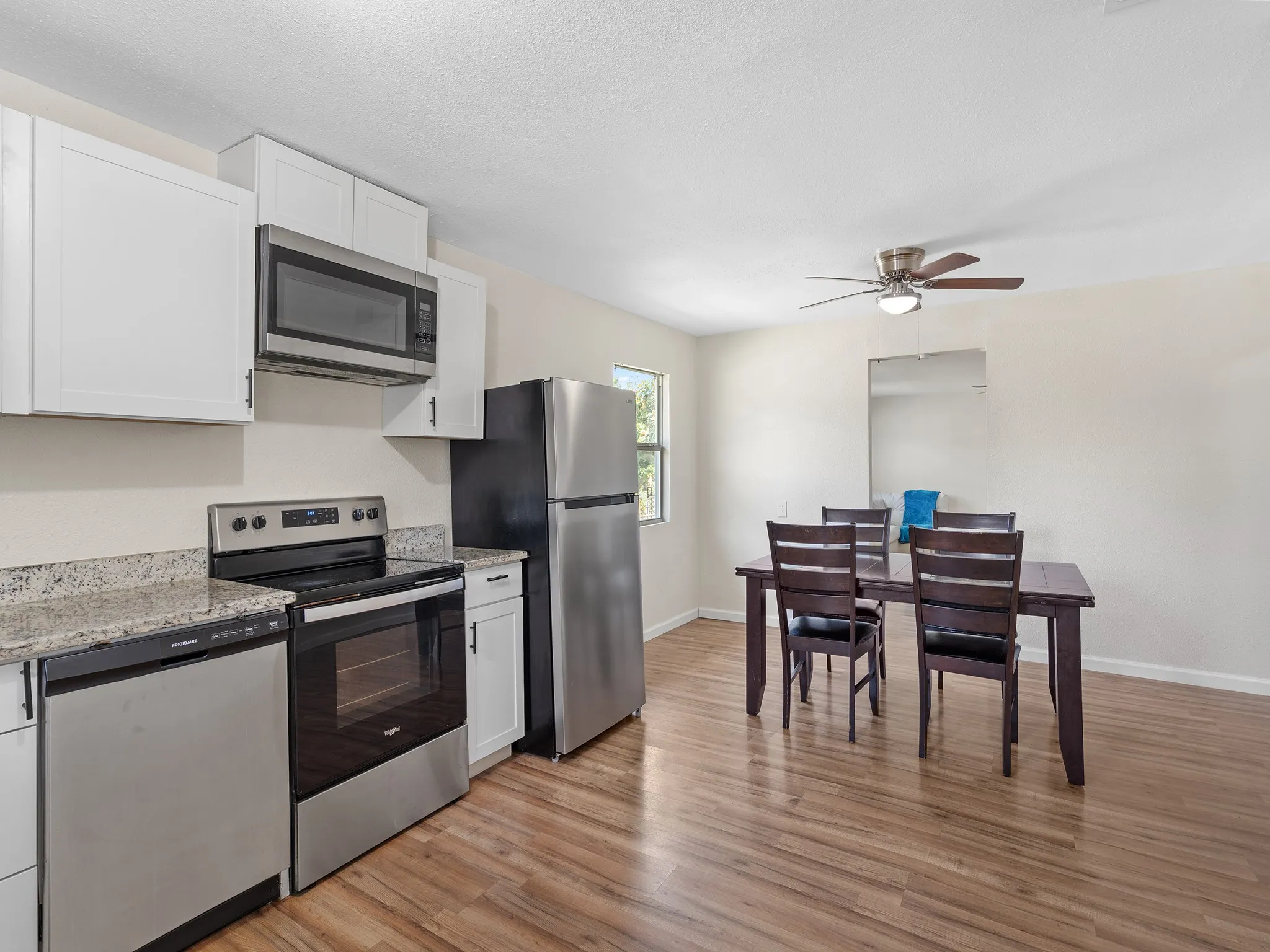Open kitchen and dining layout offers plenty of room for everyday meals and entertaining, with stainless steel appliances, bright finishes and great natural light.