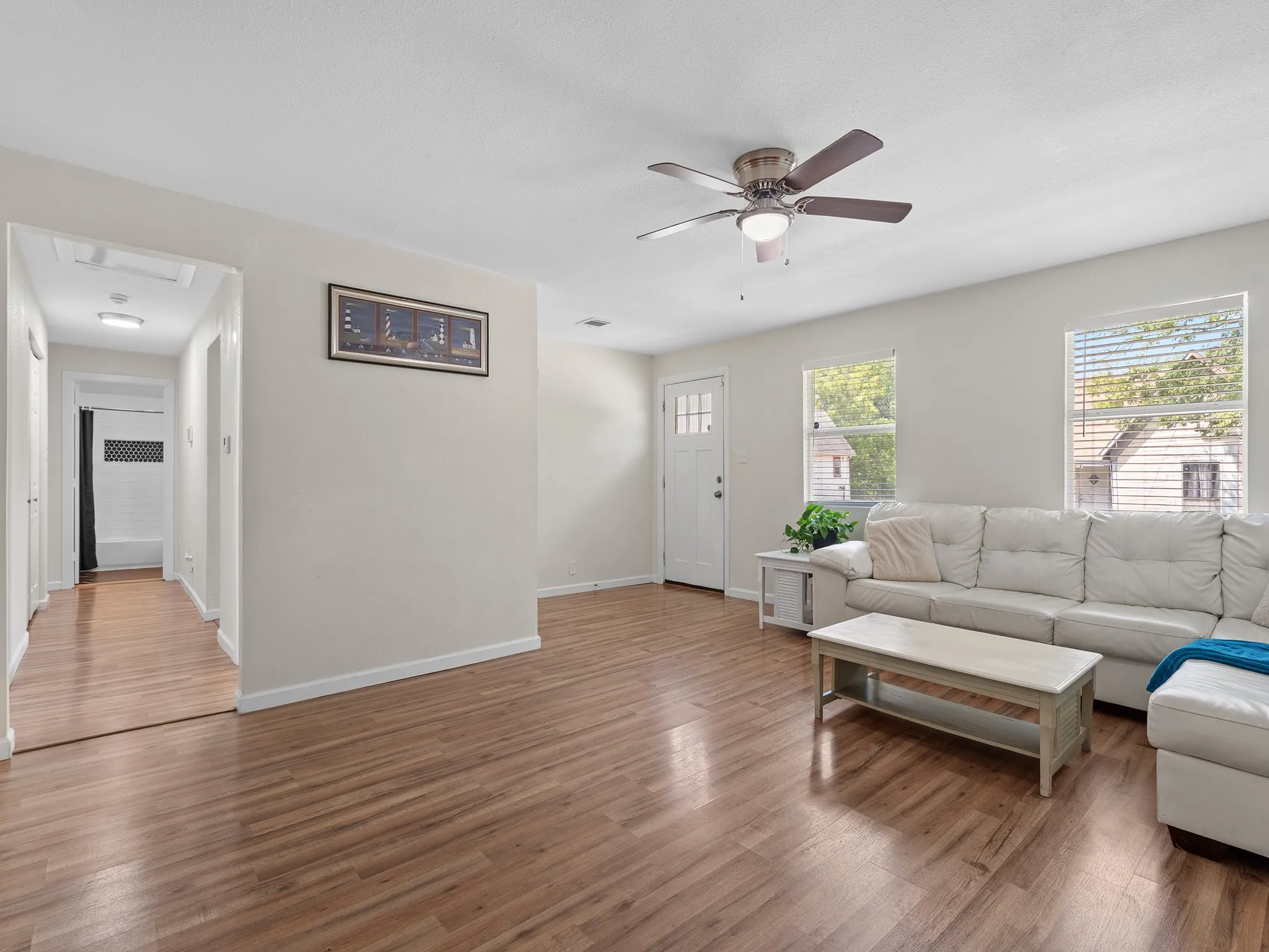 Spacious living area with smooth vinyl flooring, neutral finishes and plenty of natural light.