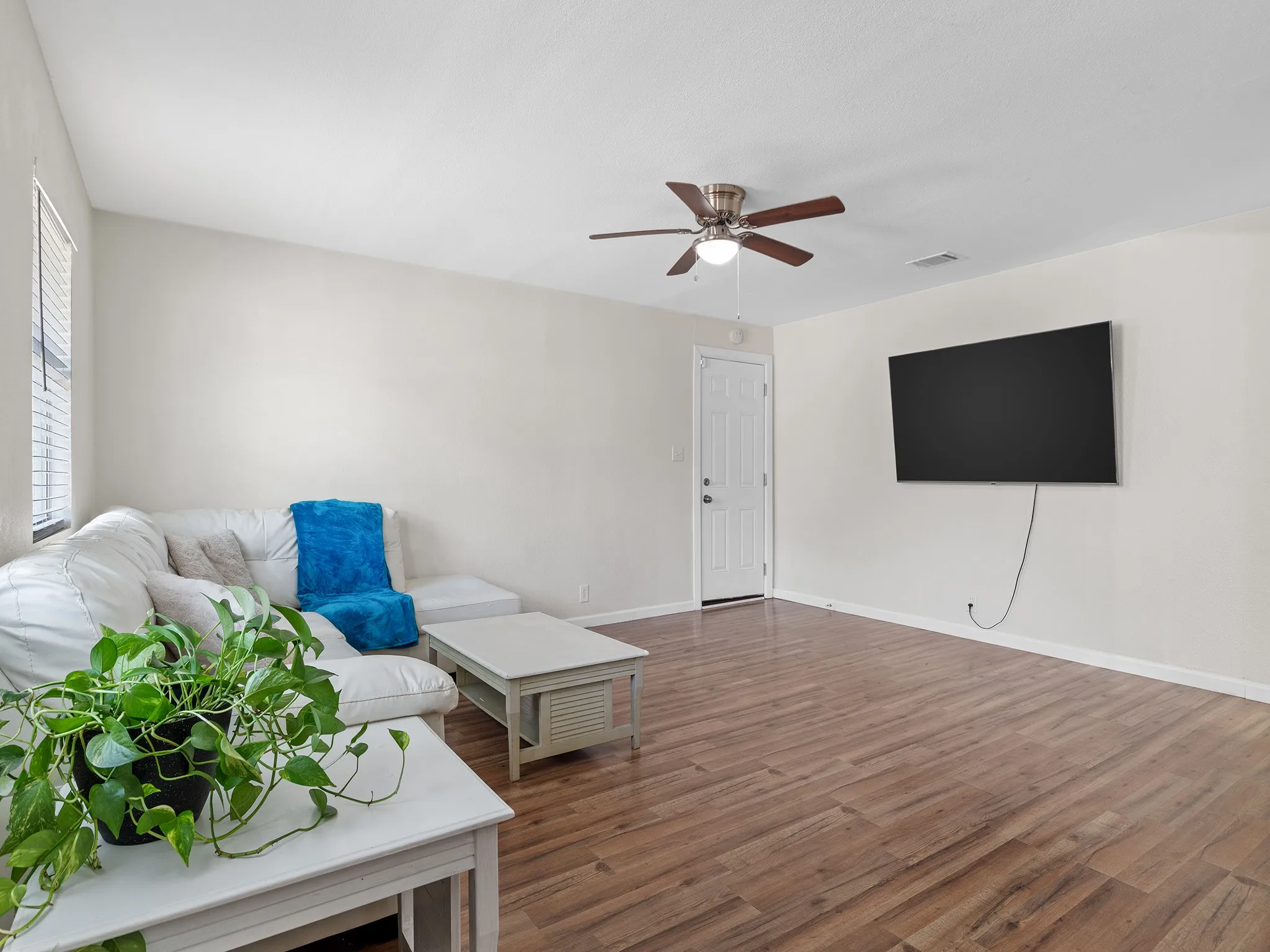 The open feel, neutral finishes, and generous wall space make this room easy to arrange for everyday living and entertaining.