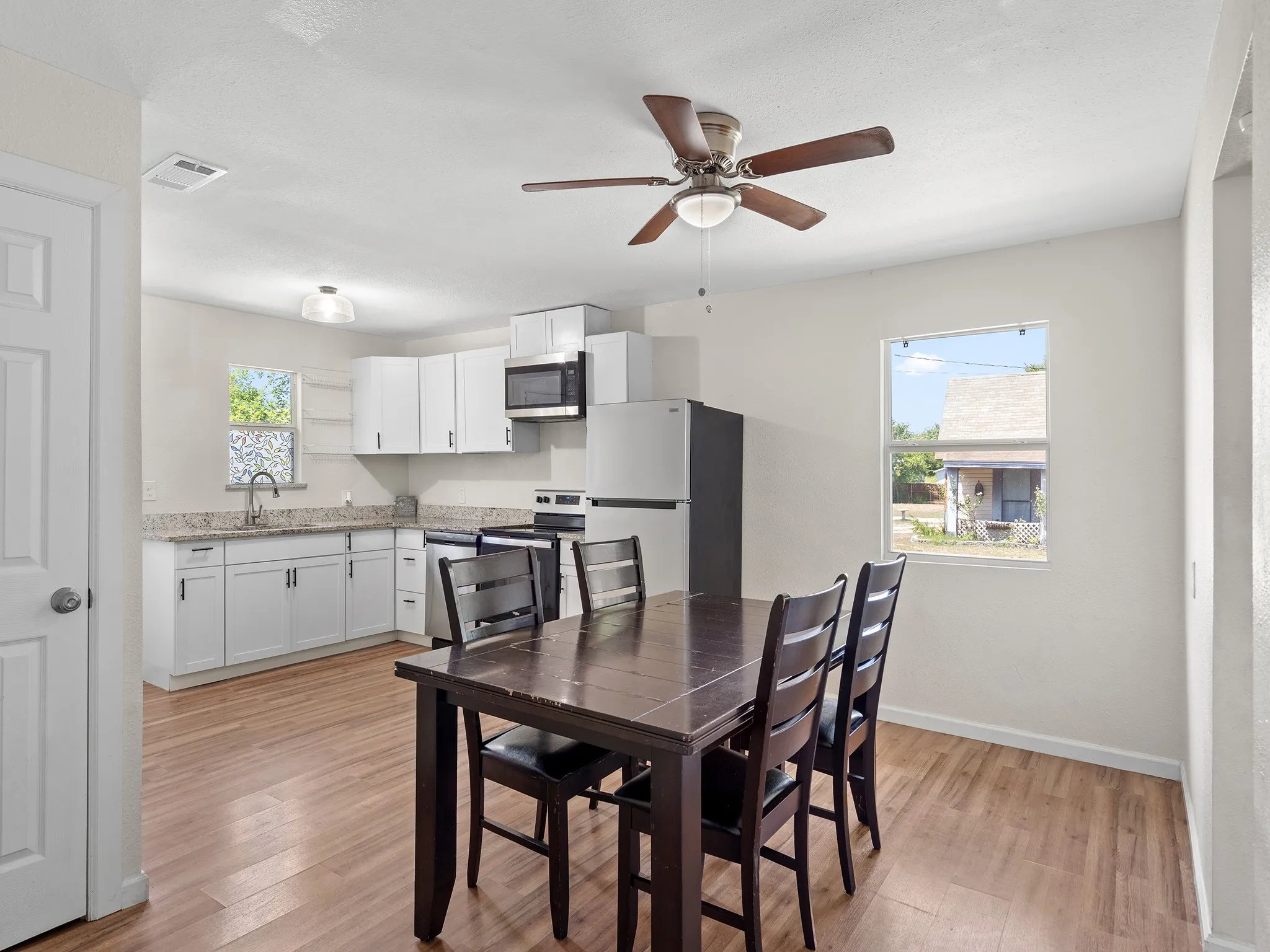 Spacious dining area flows easily into the kitchen, creating a bright, comfortable space for meals, gatherings and everyday living.