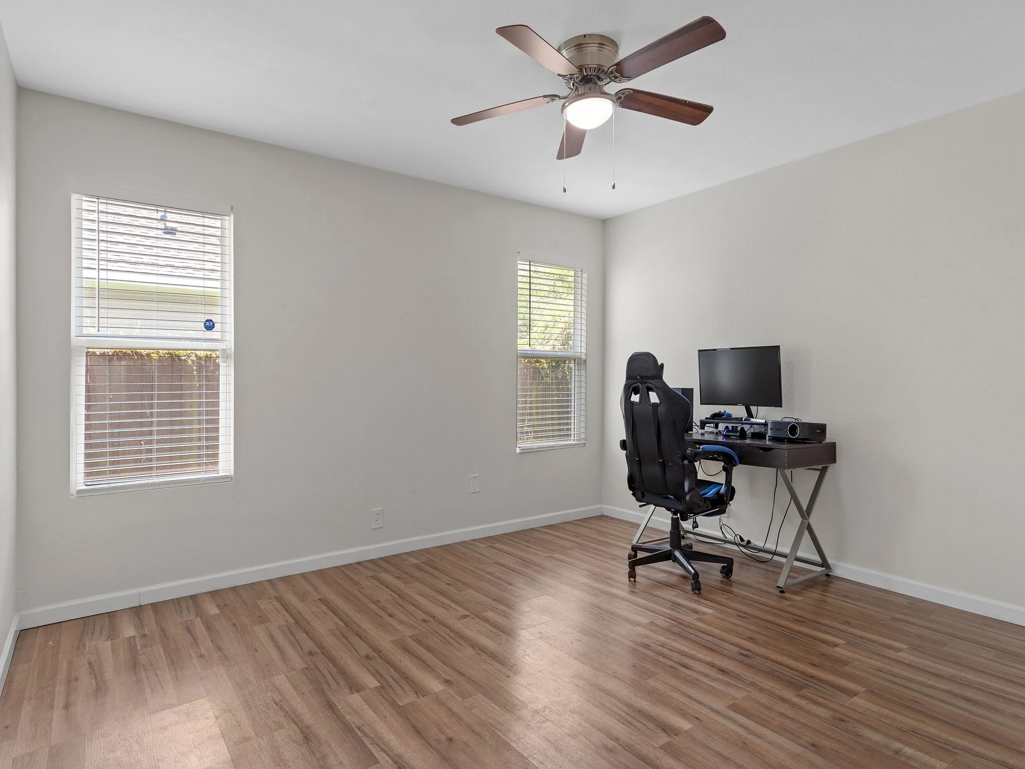 Bedroom #2 is currently set up as an office. Features smooth flooring, natural light and ceiling fan.