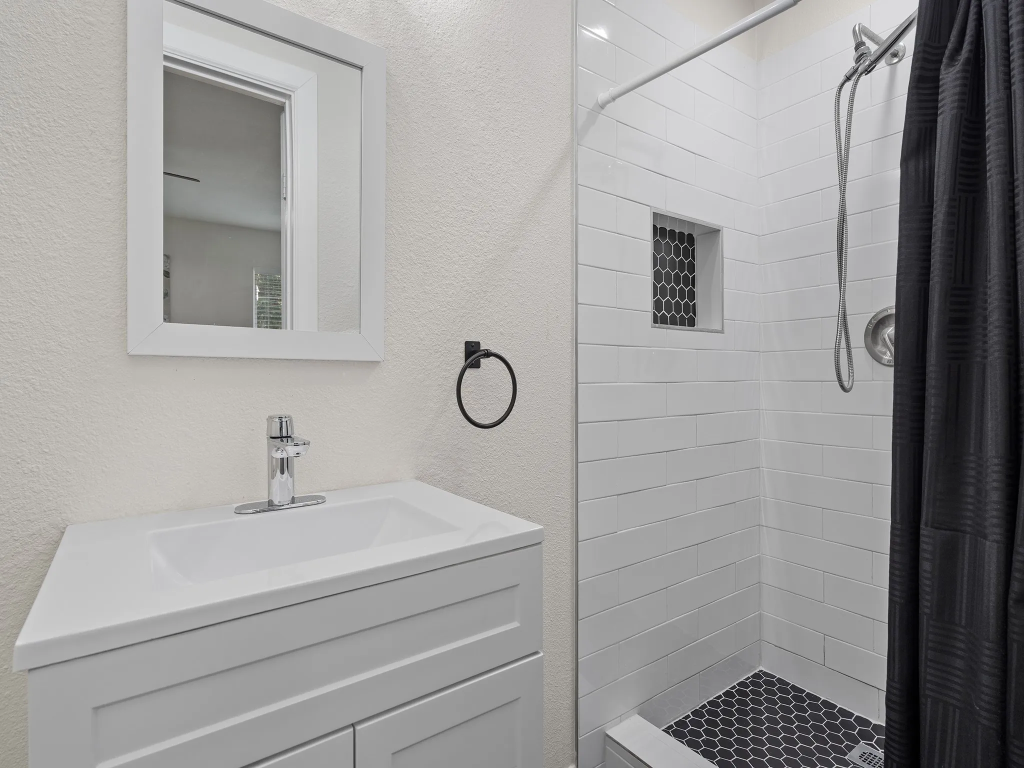 Primary en-suite bath with beautifully tiled shower and modern finishes