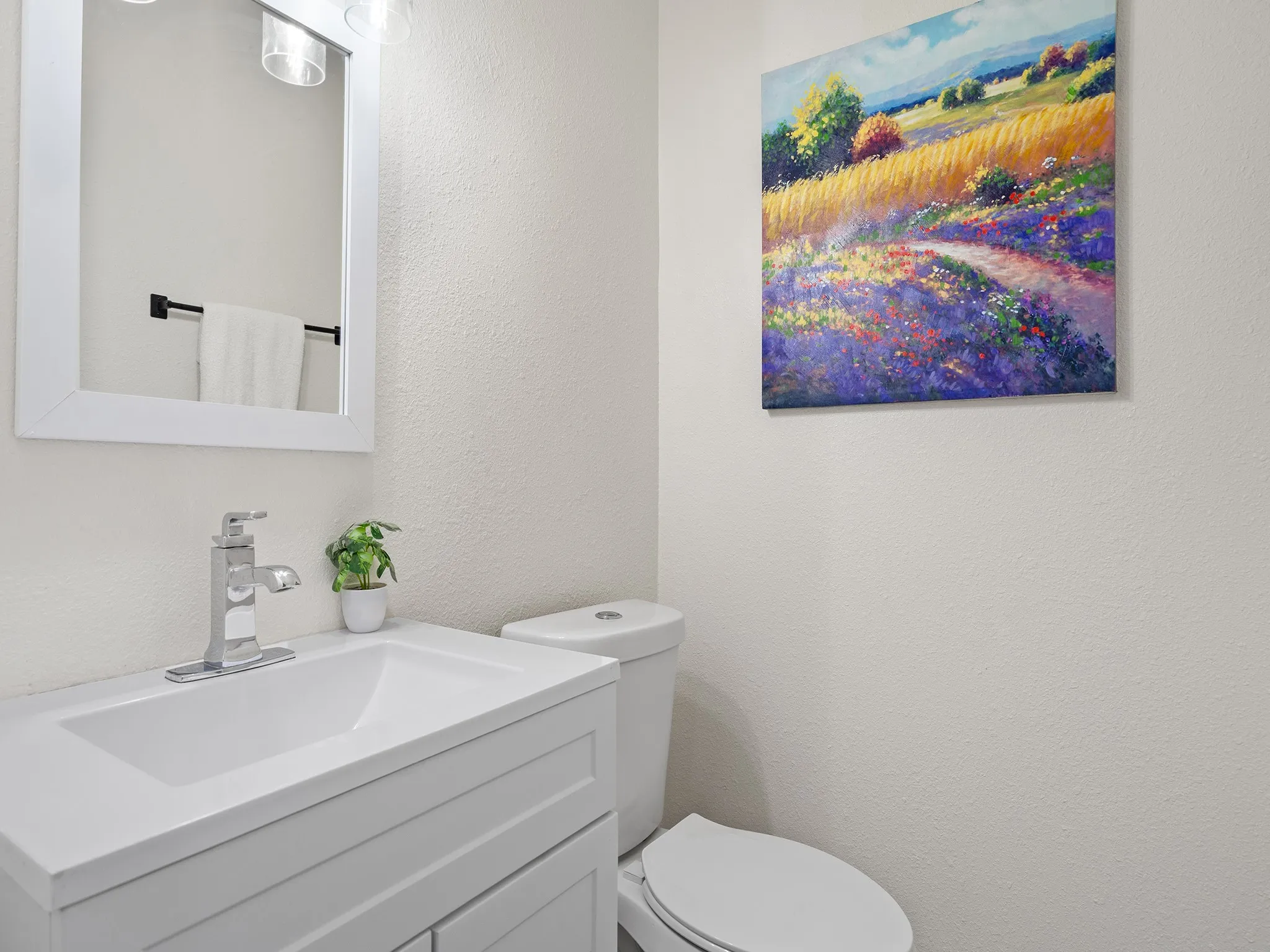 Updated half bath with a clean, modern vanity, contemporary fixtures and neutral finishes—conveniently located for guests and everyday use.