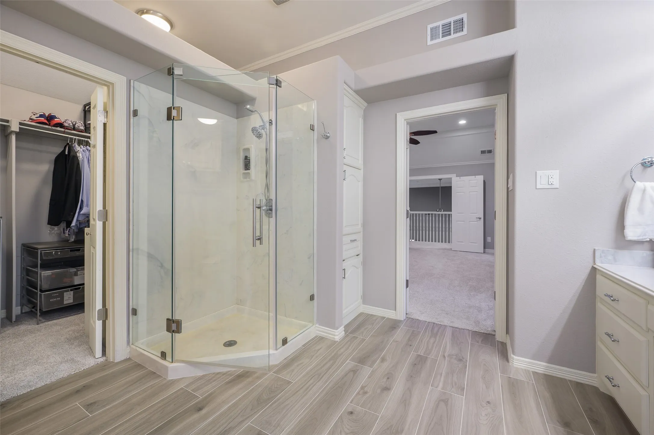 Primary bath looking into closet