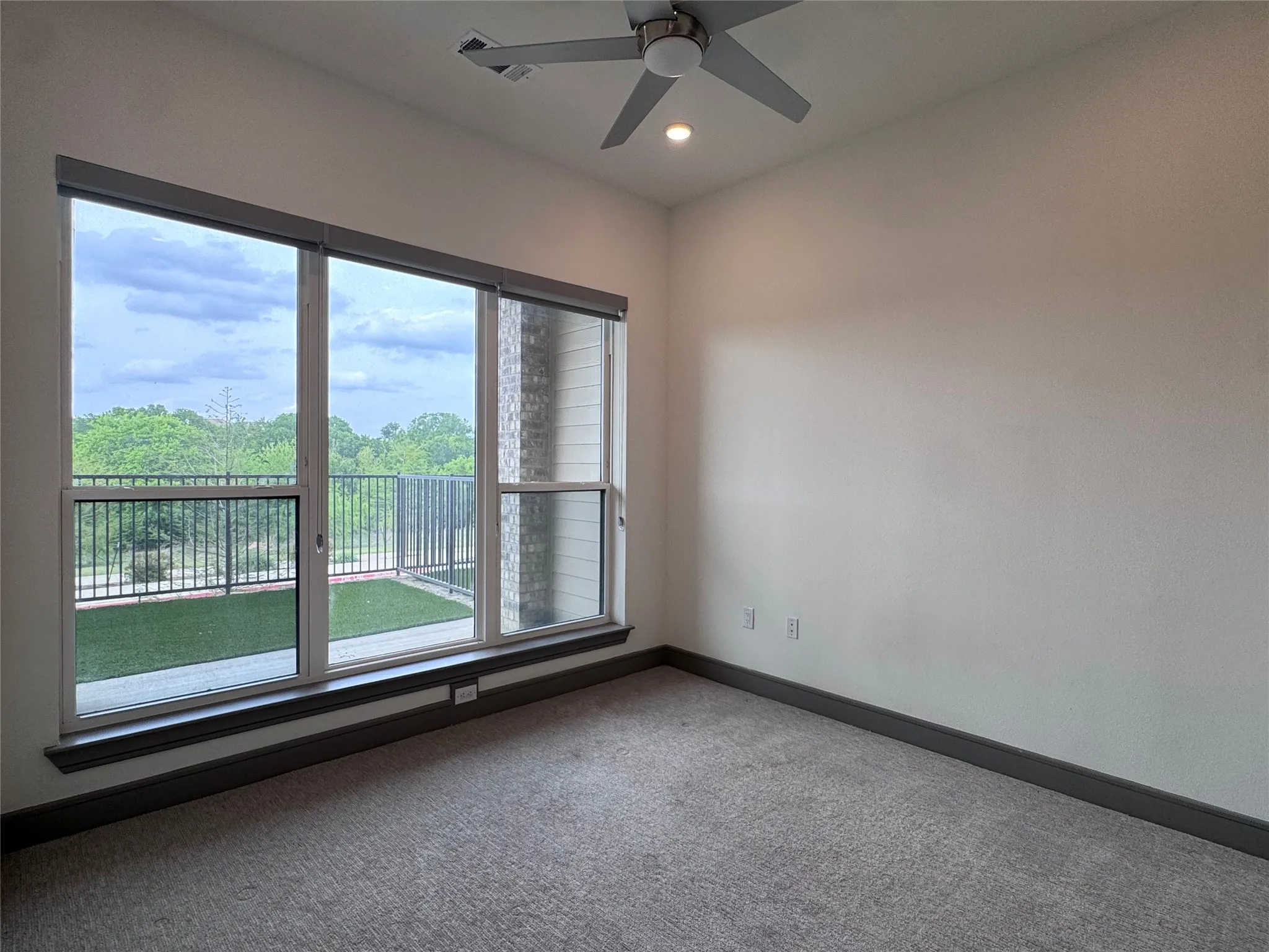Expansive window with roller shades and a sliding glass door