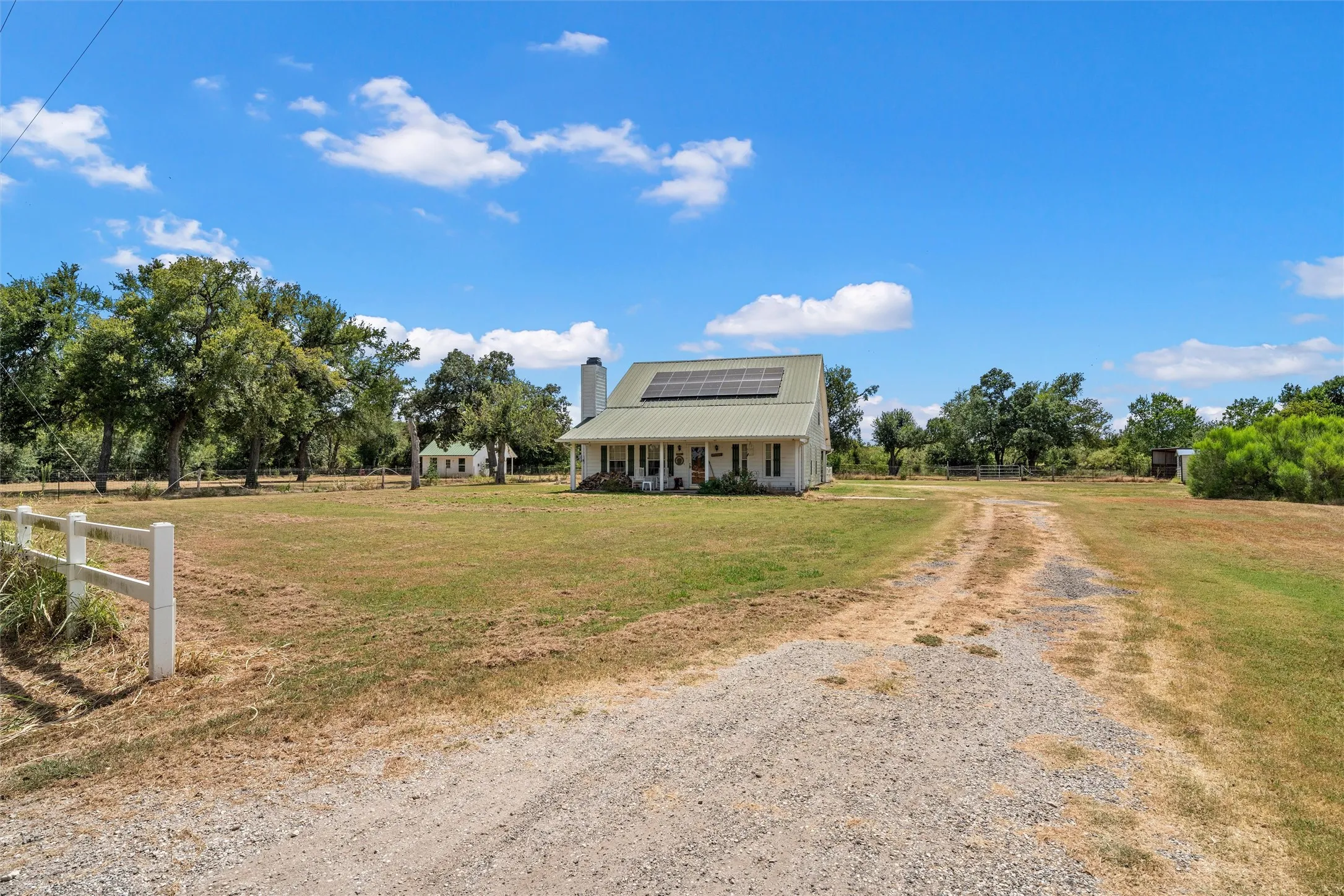 Main home, drive way, 2nd home-like structure beyond