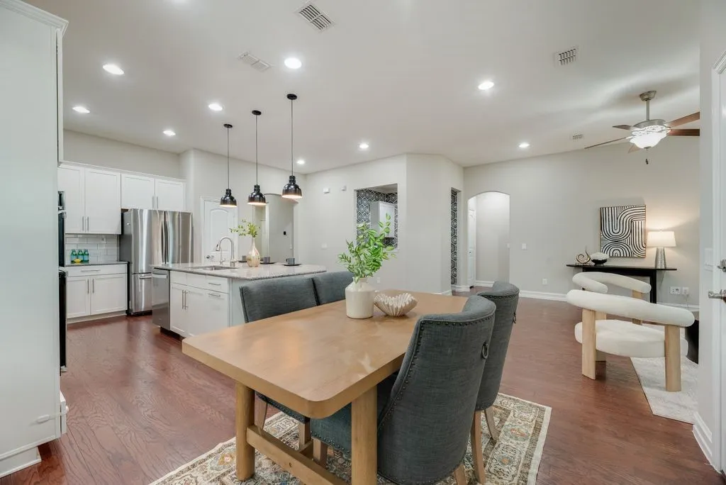 Open-concept living space featuring wood-finish flooring, recessed lighting, and a neutral color palette