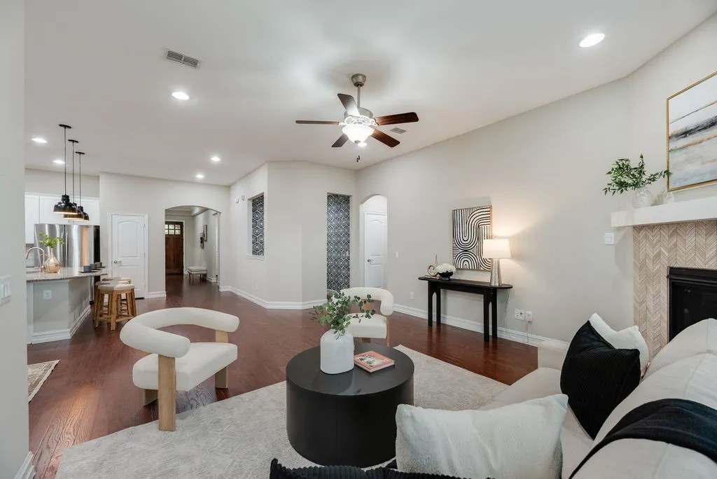 Wood-finish flooring, recessed lighting, and a ceiling fan