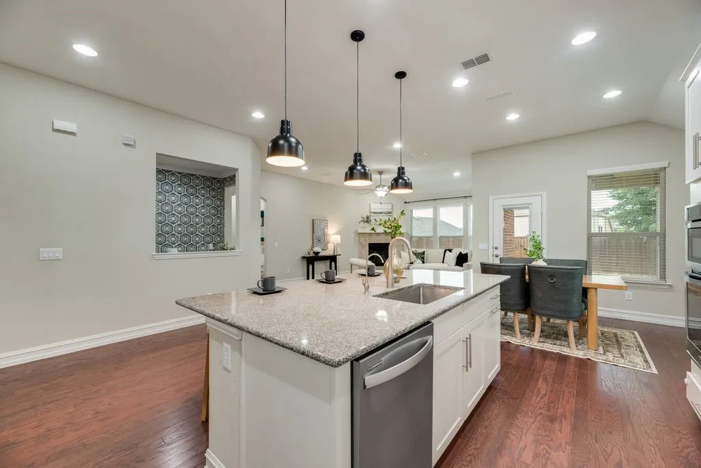 Kitchen island with a built-in sink and stainless steel dishwasher