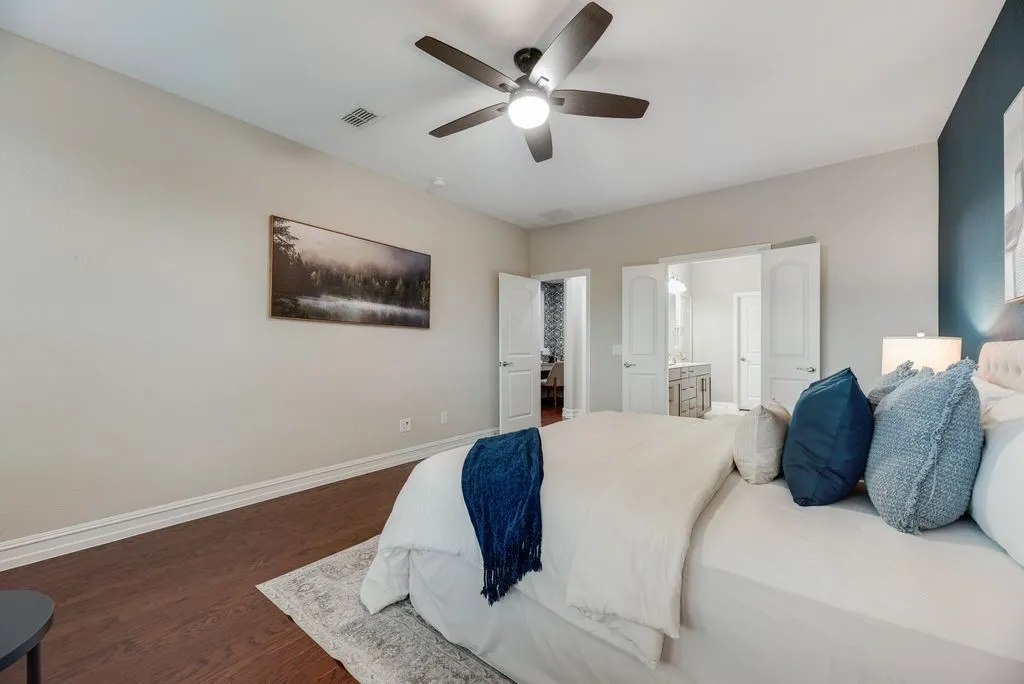 Wood-finish flooring with a ceiling fan light fixture