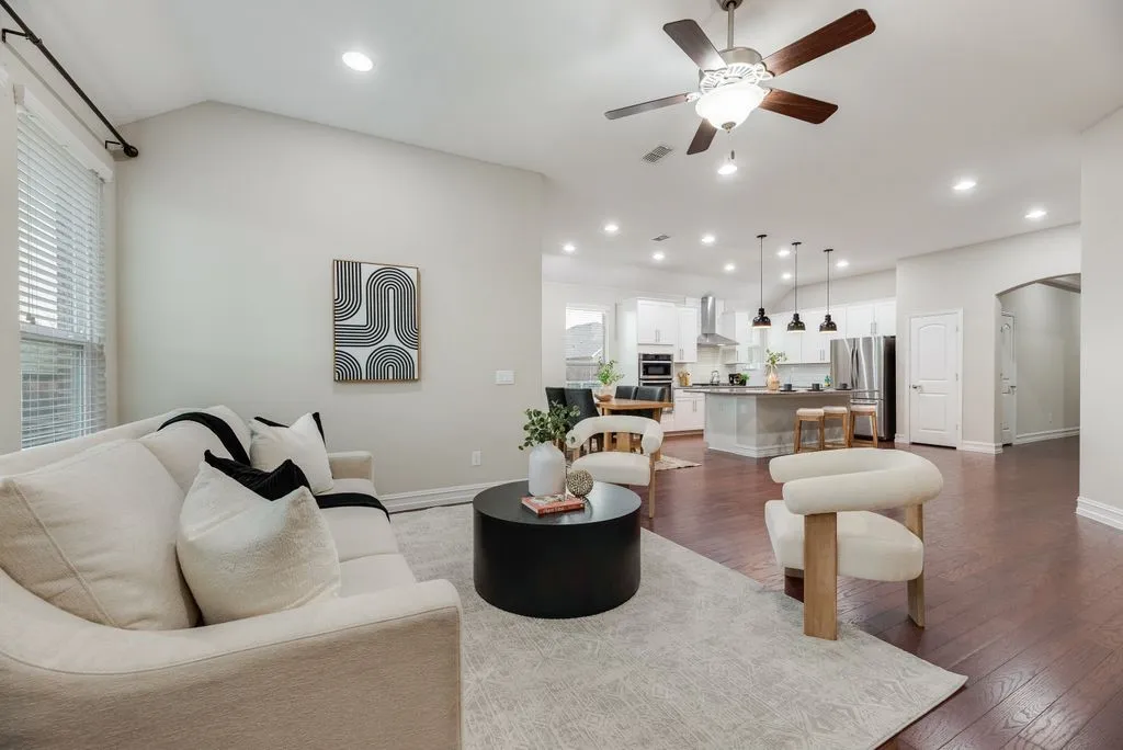 Vaulted ceiling with recessed lighting, wood-finish flooring, and a contemporary ceiling fan
