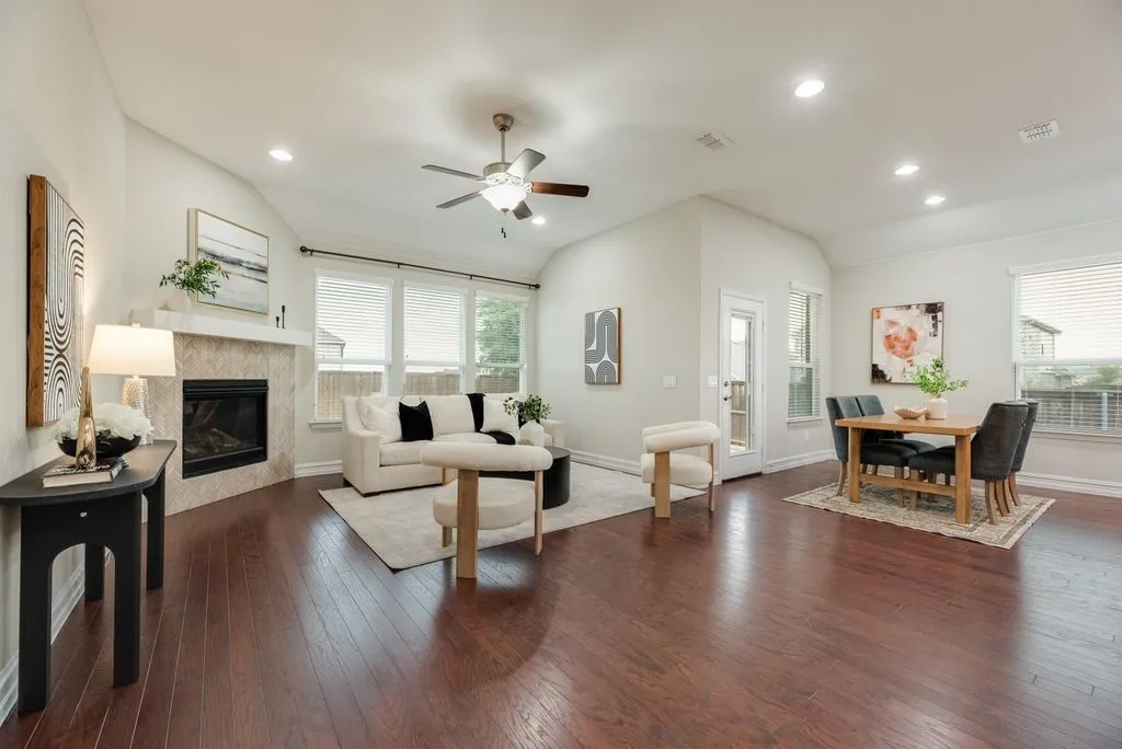 Open-concept living space with dark wood-finish flooring, recessed lighting, and a vaulted ceiling