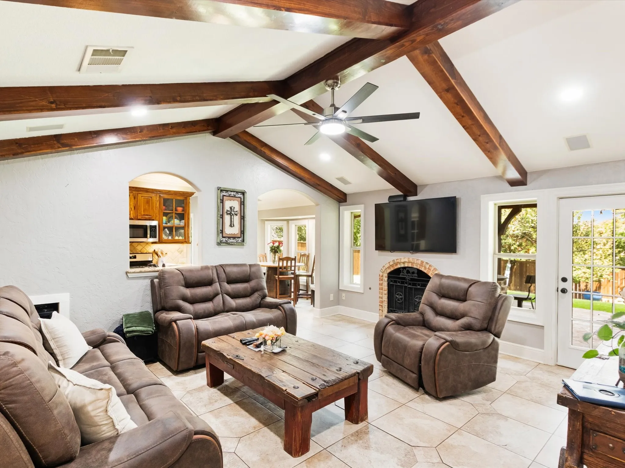Vaulted ceiling with exposed wood beams, ceiling fan, and recessed lighting