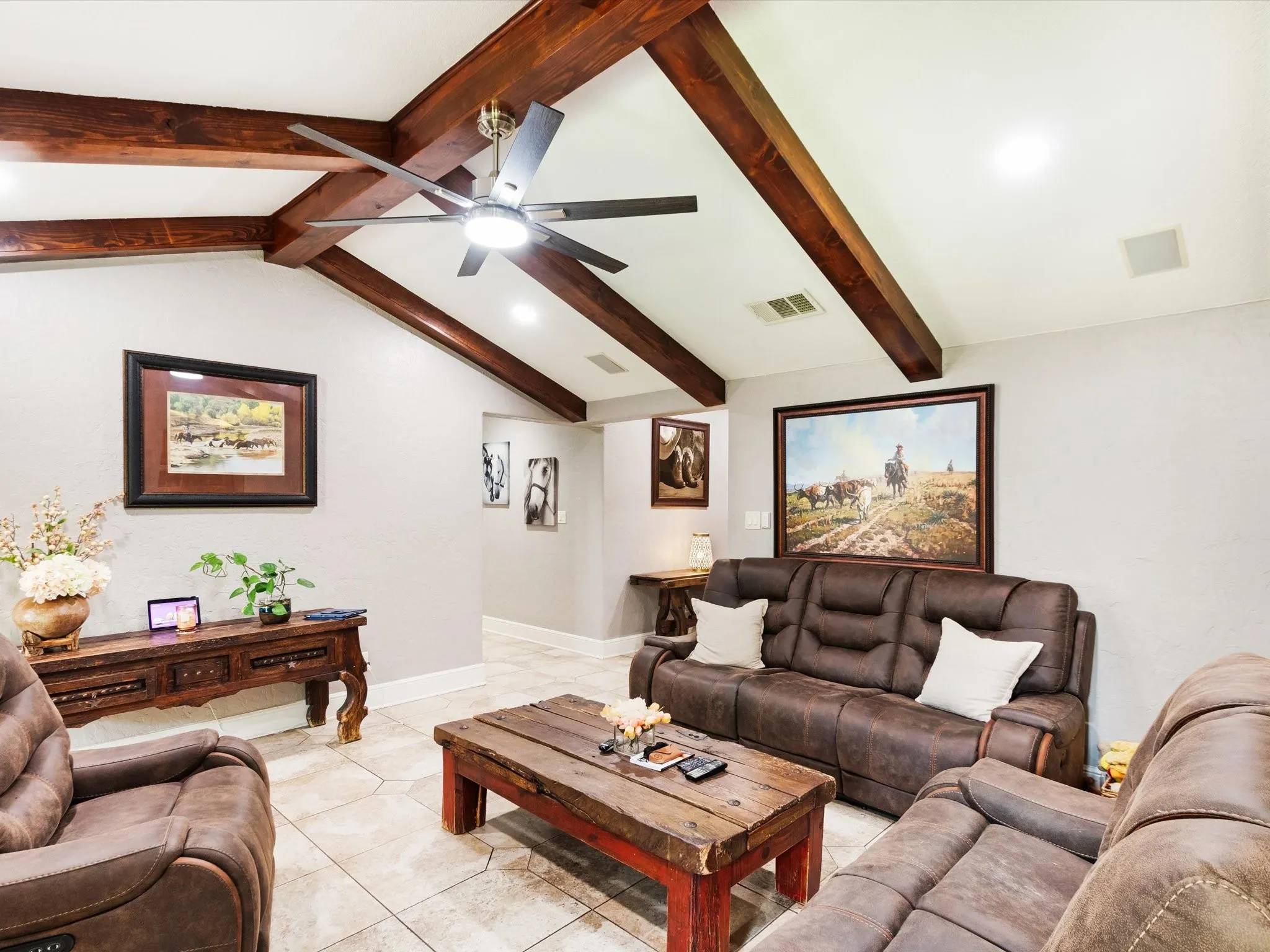 Vaulted ceiling with exposed wood beams, ceiling fan with integrated lighting, recessed lighting, and tile flooring