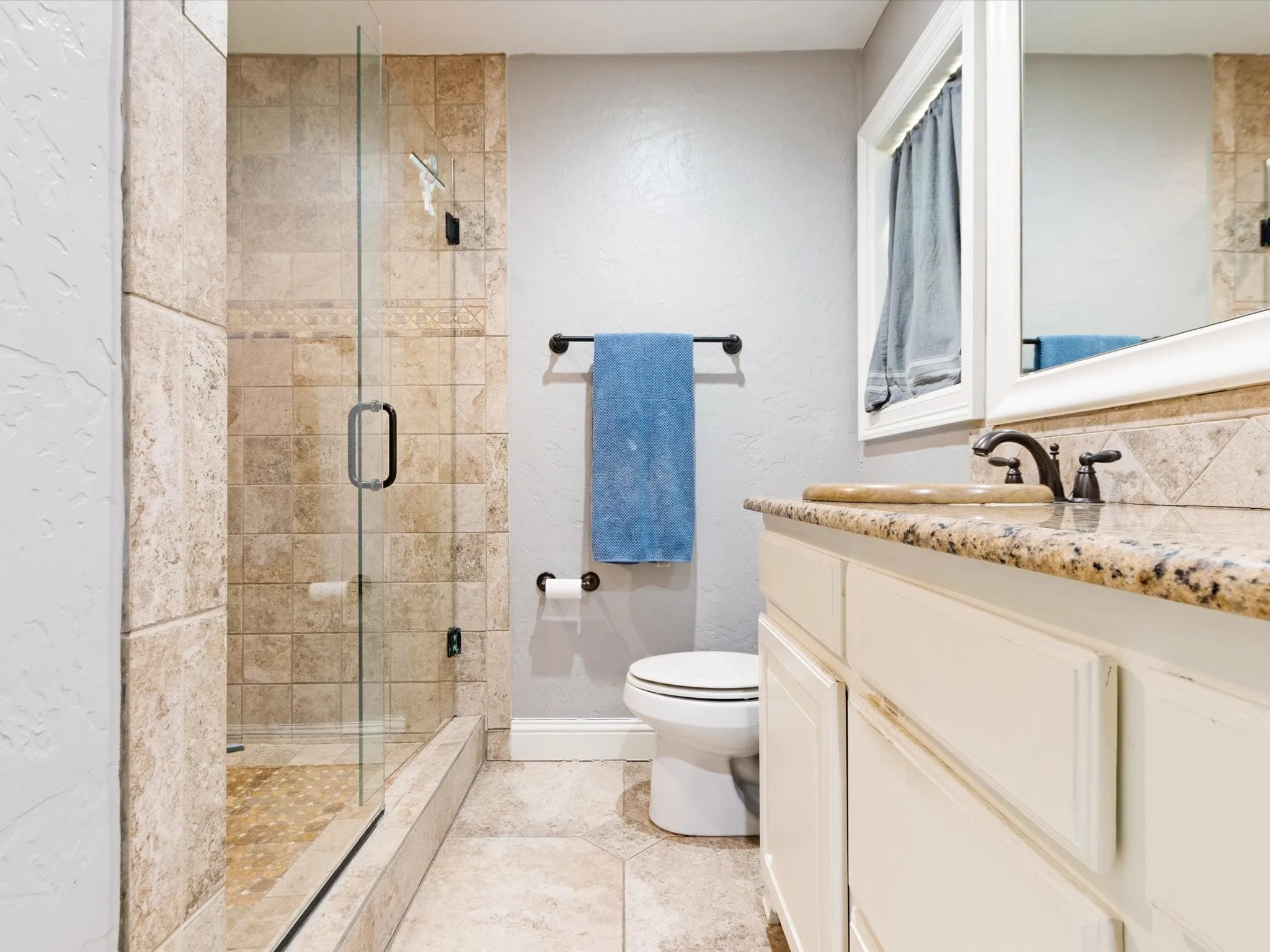 Wood-finish flooring, built-in cabinetry, and ceiling fan with integrated lighting