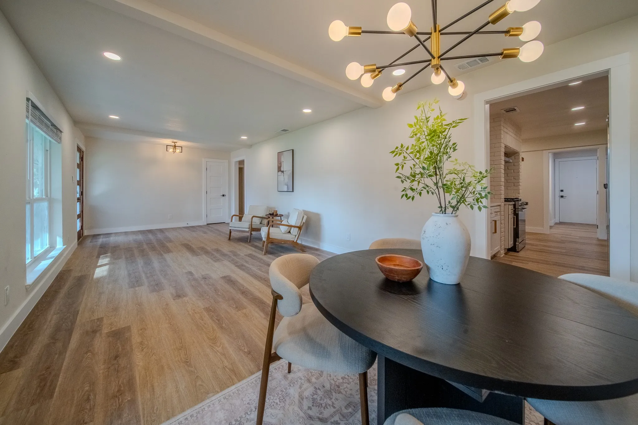 Spacious interior featuring wood-finish flooring, recessed lighting, and a contemporary chandelier