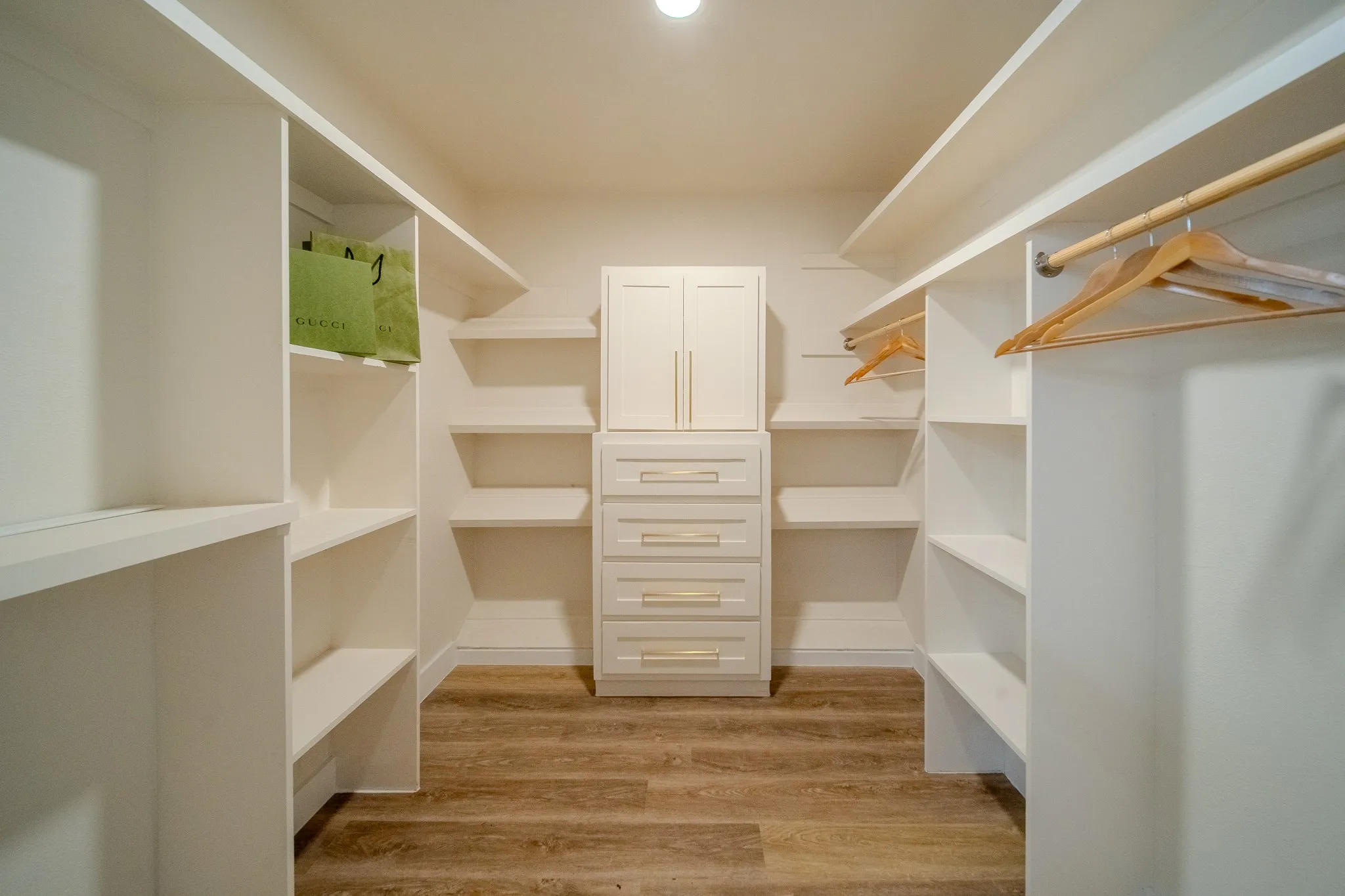 Integrated storage systems, wood-finish flooring, recessed lighting, built-in shelving, and hanging rods