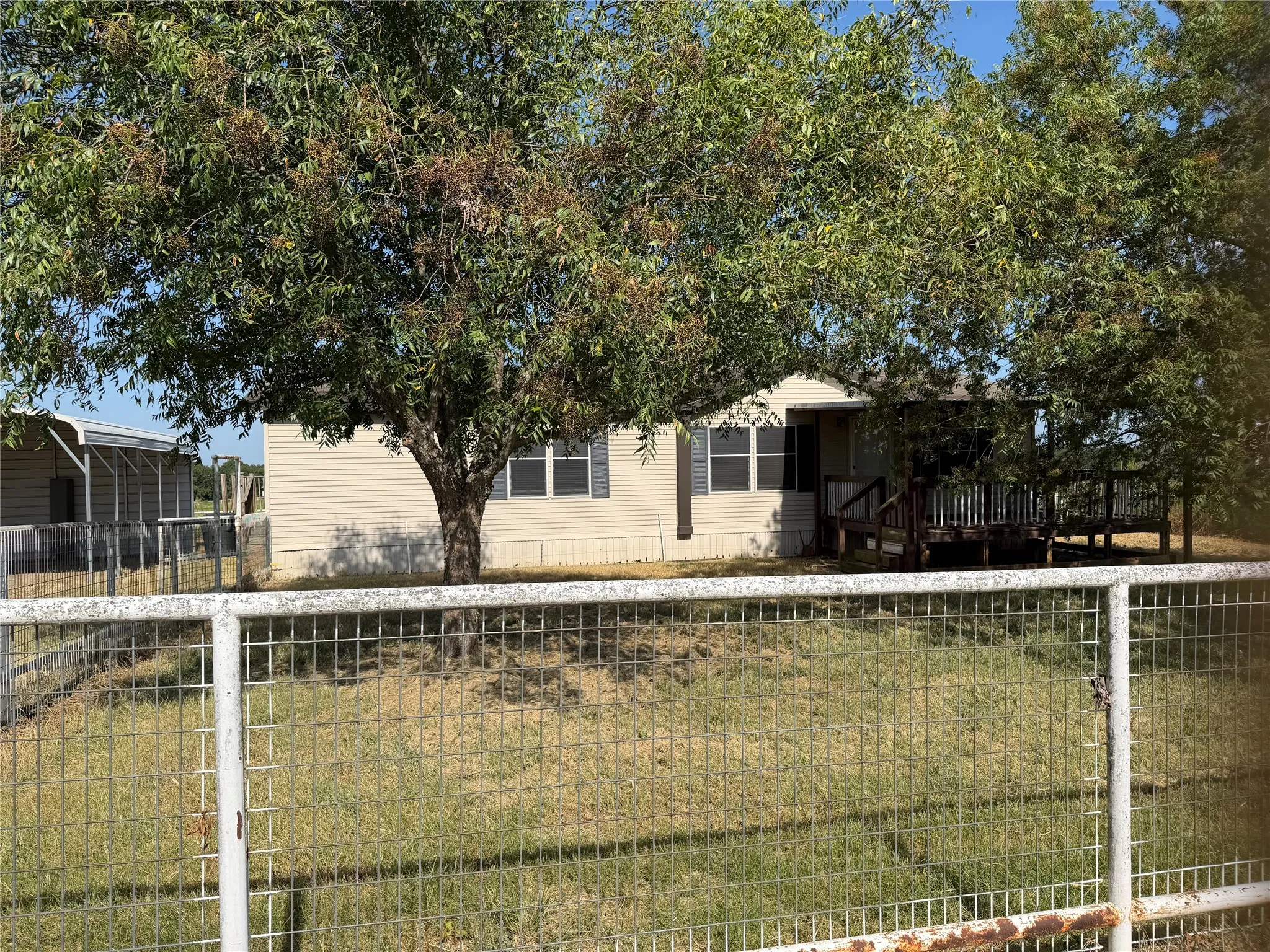 Mobile home and adjacent carport.