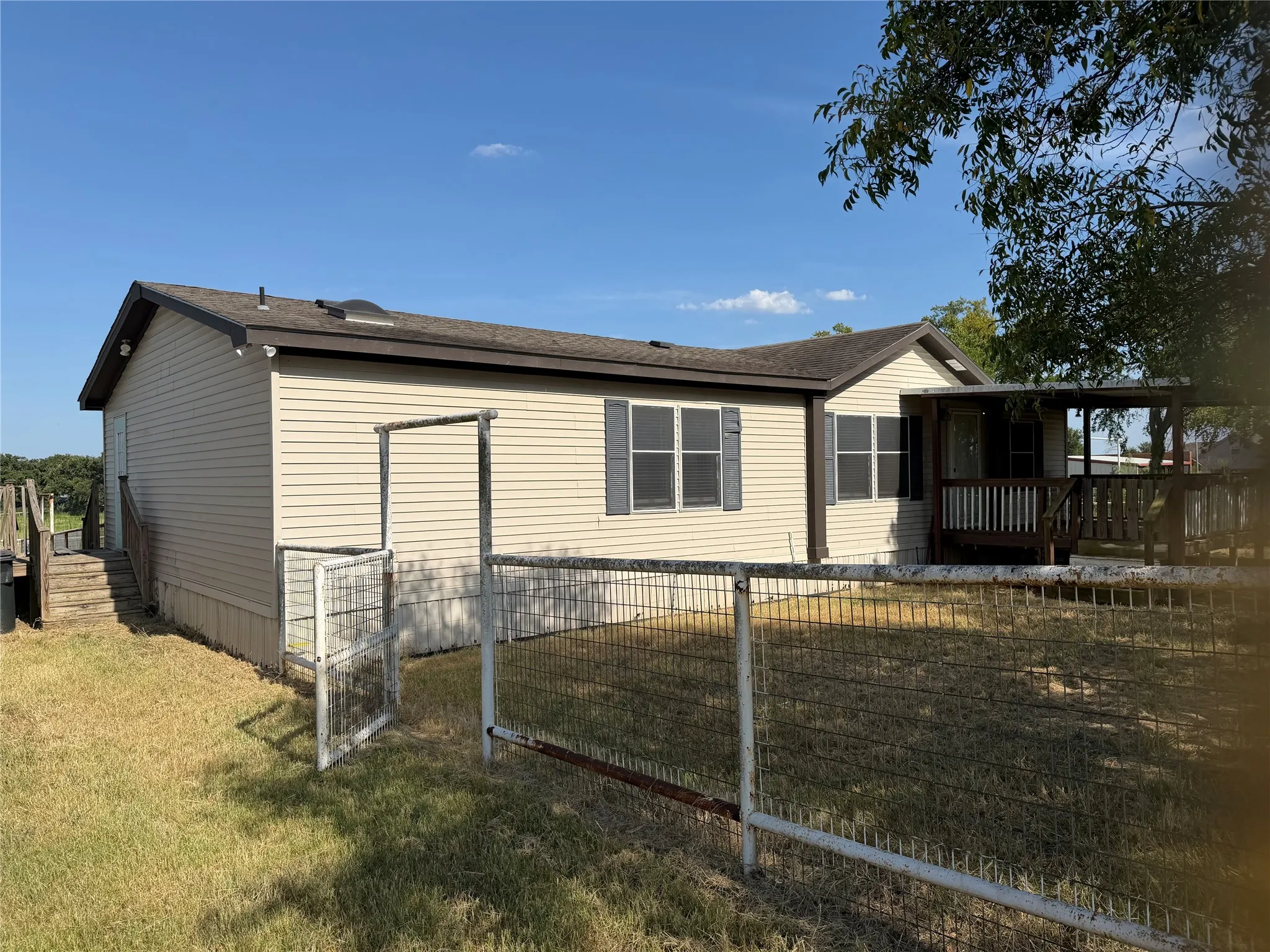3-bedroom, 2-bath Mobile home with covered front porch and fenced yard.