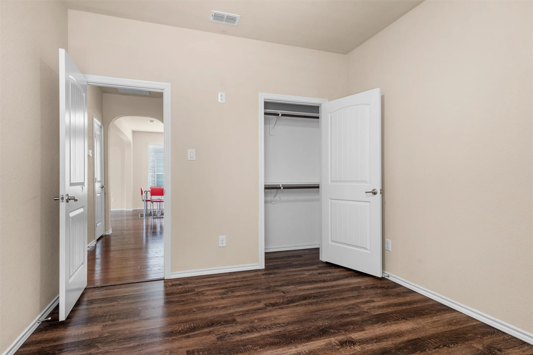 Third bedroom - Wood-finish flooring, neutral wall tones, window with horizontal blinds, and a ceiling fan with light fixture